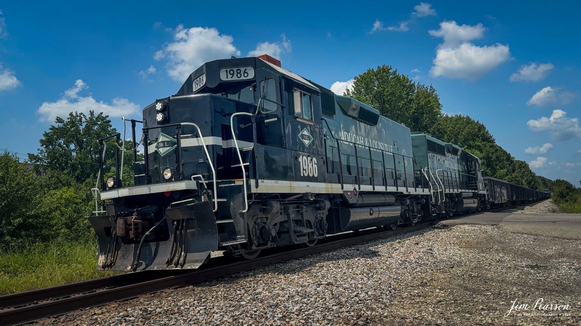 Paducah and Louisville Railway 35th Anniversary Units, 1986 and 2021 lead the daily local south at East Diamond after doing their interchange work with CSX at Atkinson Yard in Madisonville, Ky, on August 2nd, 2025.

The two Paducah & Louisville Railway locomotives were repainted by Progress Rails shops in Mayfield, KY, and numbered to reflect the 35th anniversary of the 280-mile short line, formed from former Illinois Central Gulf lines in 1986.

According to Wikipedia: The Paducah & Louisville Railway is a Class II railroad that operates freight service between Paducah and Louisville, Kentucky. The line is located entirely within the Commonwealth of Kentucky. The 270-mile line was purchased from Illinois Central Gulf Railroad in August 1986.

Tech Info: iPhone 16pro Frame Grab from 4K Video.

#trainphotography #railroadphotography #trains #railways #trainphotographer #railroadphotographer #jimpearsonphotography #trains #paducahandlouisvillerailway
