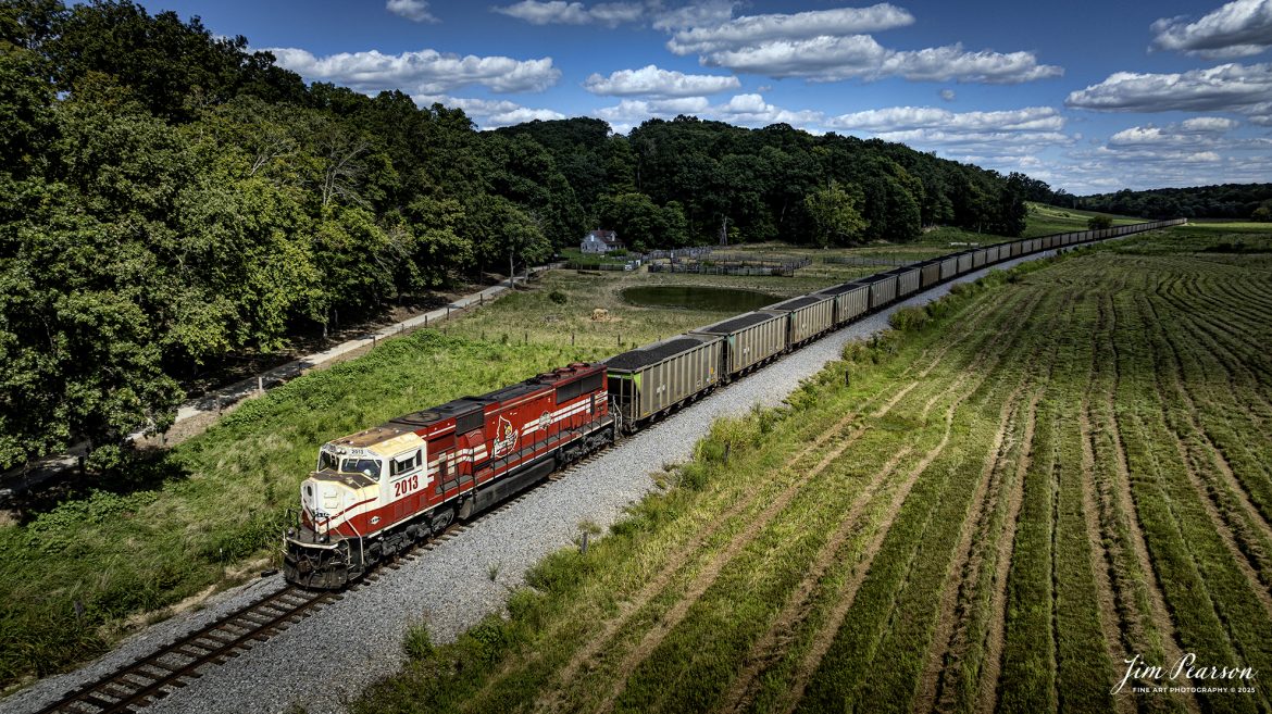 Paducah and Louisville Railway 2013 University of Louisville locomotive brings up the rear as the DPU on a northbound loaded Louisville, Gas and Electric coal train as they pass through the valley at Do Stop, just south of Caneyville, Kentucky, on August 26th, 2025. 

According to Wikipedia: The Paducah & Louisville Railway (reporting mark PAL) is a Class II railroad that operates freight service between Paducah and Louisville, Kentucky. The line is located entirely within the Commonwealth of Kentucky.

The 270-mile (430 km) line was purchased from Illinois Central Gulf Railroad in August of 1986.

Tech Info: DJI Mavic 3 Classic Drone, RAW, 22mm, f/2.8, 1/2000, ISO 100

#railroad #railroads #train, #trains #railway #railway #steamtrains #railtransport #railroadengines #picturesoftrains #picturesofrailways #besttrainphotograph #bestphoto #photographyoftrains #bestsoldpicture #JimPearsonPhotography #trainsfromtheair #trainsfromadrone #paducahandlouisvillerailway