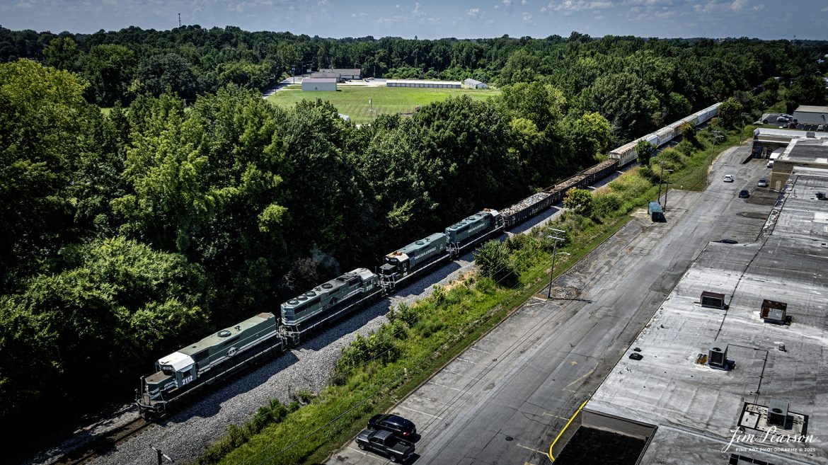 Paducah and Louisville Railway 2112, 2119, 1986 and 2021 le4ad the daily local out of CSX Atkinson Yard at Madisonville, Kentucky as they complete their interchange work there on August 6th, 2025. They will continue south on the CSX Henderson Subdivision cutoff till they reach the interchange track which takes them back to their trackage where they will head south, back to Princeton, Kentucky.

Tech Info: DJI Mavic 3 Classic Drone, RAW, 22mm, f/2.8, 1/3200, ISO 110

#railroad #railroads #train, #trains #railway #railway #railtransport #railroadengines #picturesoftrains #picturesofrailways #besttrainphotograph #bestphoto #photographyoftrains #bestsoldpicture #JimPearsonPhotography #trainsfromtheair #trainsfromadrone #paducahandlouisvillerailway