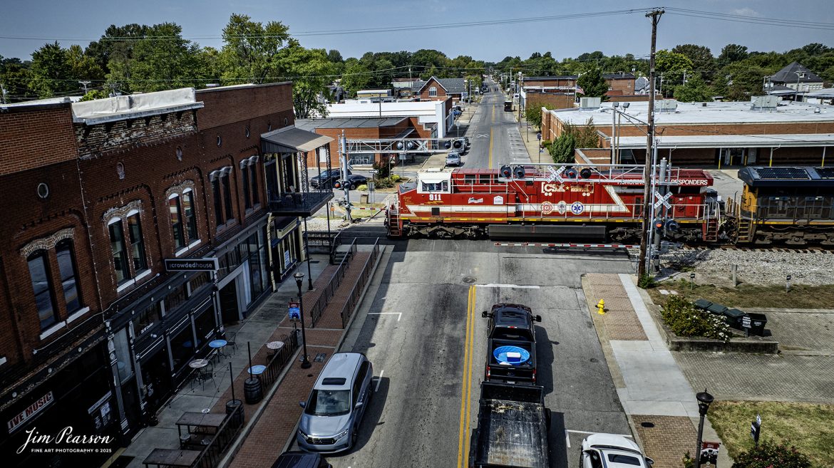 CSXT 911, Honoring First Responders Locomotive, leads southbound I025 as it passes over the Center Street Crossing at Madisonville, Kentucky on September 10th, 2025, on the CSX Henderson Subdivision.

CSXT 911 is painted in vibrant red with white and gold striped accents along with the logo of program partners First Responders Children’s Foundation and Operation Gratitude. It also features generic police, fire and emergency medical services logos.

Tech Info: DJI Mavic 3 Classic Drone, RAW, 22mm, f/2.8, 1/2000, ISO 110

#railroad #railroads #train, #trains #railway #railway #railtransport #railroadengines #picturesoftrains #picturesofrailways #besttrainphotograph #bestphoto #photographyoftrains #bestsoldpicture #JimPearsonPhotography #trainsfromtheair #trainsfromadrone #onecsx #csx