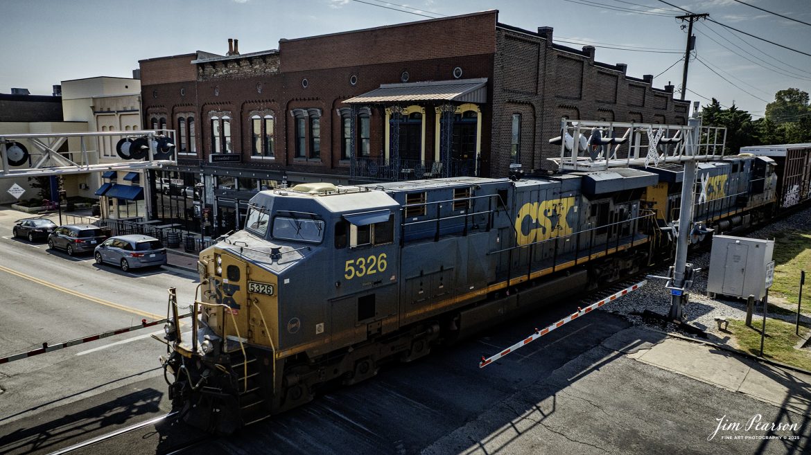 CSXT 5326 leads local L391 as they pass through the West Center Street crossing in downtown Madisonville, Ky heading north to CSX Atkinson Yard for their daily work between Hopkinsville and Madisonville, on September 10th, 2025, on the CSX Henderson Subdivision.

Tech Info: DJI Mavic 3 Classic Drone, RAW, 22mm, f/2.8, 1/4000, ISO 220

#railroad #railroads #train, #trains #railway #railway #railtransport #railroadengines #picturesoftrains #picturesofrailways #besttrainphotograph #bestphoto #photographyoftrains #bestsoldpicture #JimPearsonPhotography #trainsfromtheair #trainsfromadrone #onecsx #csx