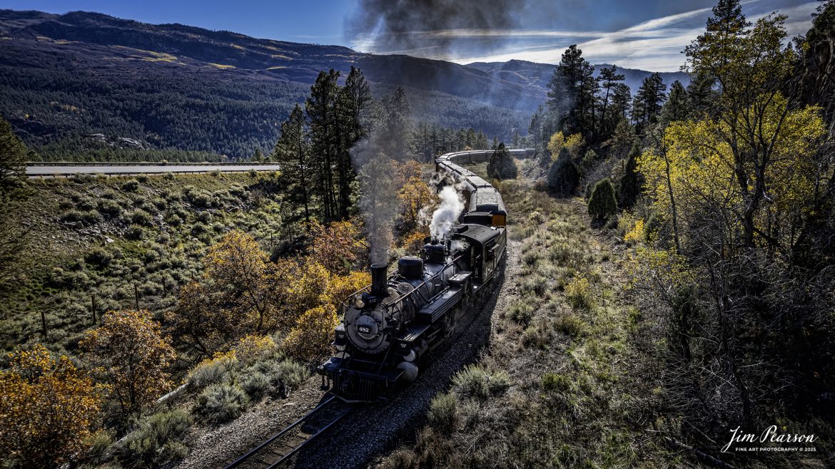 Durango and Silverton Narrow Gauge Railroad locomotive 482 leads the daily passenger train as it heads through the S curve approaching Rockwood on the way to Silverton, Colorado on October 22nd. 2025.

D&SNG No. 482 is a K-36 class 2-8-2 "Mikado" type narrow gauge steam locomotive. It was originally built by the Baldwin Locomotive Works in 1925 for the Denver & Rio Grande Western Railroad (D&RGW) and is now preserved as a permanent resident of the Durango & Silverton Narrow Gauge Railroad (D&SNG) in Durango, CO.

The Durango and Silverton Narrow Gauge Railroad, often abbreviated as the D&SNG, is a 3 ft (914 mm) narrow-gauge heritage railroad that operates on 45.2 miles (72.7 km) of track between Durango and Silverton, in the U.S. state of Colorado. The railway is a federally designated National Historic Landmark and was also designated by the American Society of Civil Engineers as a National Historic Civil Engineering Landmark in 1968.

The route was originally opened in 1882 by the Denver and Rio Grande Railroad (D&RG) to transport silver and gold ore mined from the San Juan Mountains. The line was the "San Juan" extension of the D&RG 3 ft (914 mm) narrow-gauge line from Antonito, Colorado, to Durango. The last train to operate into Durango from the east was on December 6, 1968.

The line from Durango to Silverton has run continuously since 1881, although it is now a tourist and heritage line hauling passengers, and is one of the few places in the US which has seen continuous use of steam locomotives.

Tech Info: DJI Air 2S Drone, RAW, 22mm, f/2.8, 1/1000, ISO 150

#trains #railway #JimPearsonPhotography #trainsfromadrone #steamtrains #D&SNG