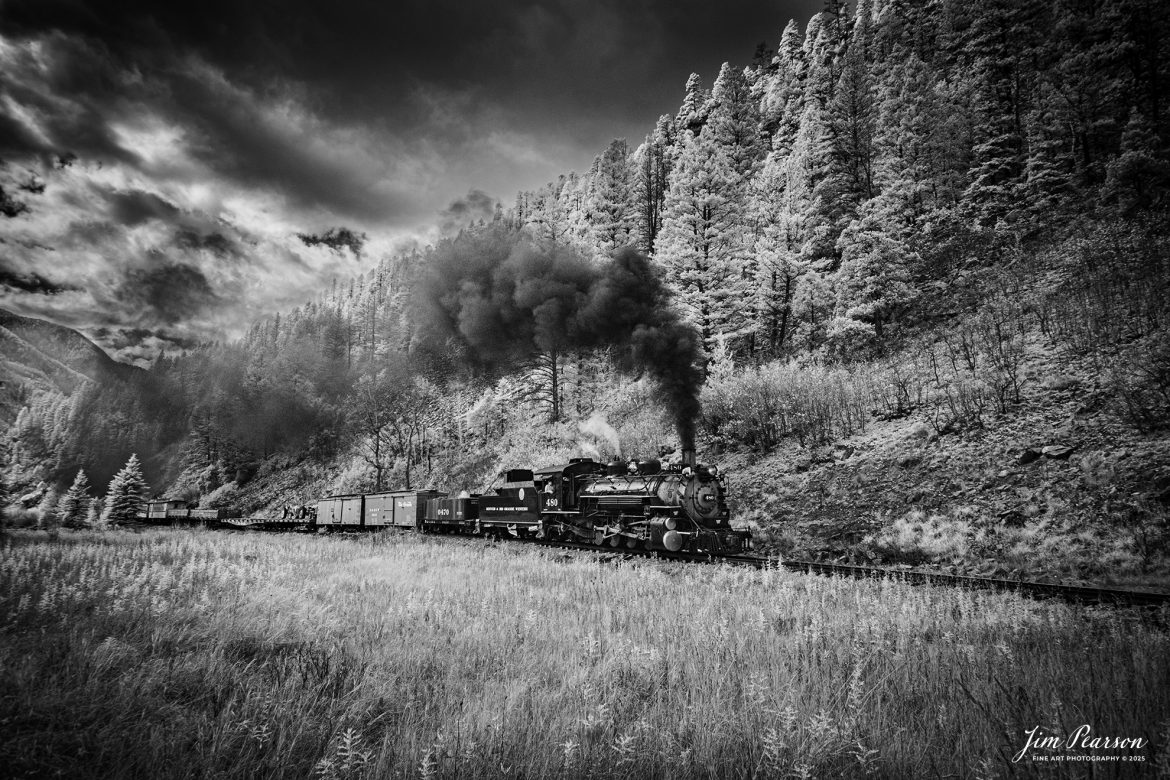 In this week’s Saturday Infrared photo, we catch Durango and Silverton Narrow Gauge Railroad locomotive 480 as it leads the fall photo charter freight train as it heads to Silverton, Colorado on October 24th. 2025.

D&SNG No. 480 is a K-36 class 2-8-2 "Mikado" type narrow gauge steam locomotive. It was originally built by the Baldwin Locomotive Works in 1925 for the Denver & Rio Grande Western Railroad (D&RGW). It is now a permanent resident of the Durango & Silverton Narrow Gauge Railroad.

The Durango and Silverton Narrow Gauge Railroad, often abbreviated as the D&SNG, is a 3 ft (914 mm) narrow-gauge heritage railroad that operates on 45.2 miles (72.7 km) of track between Durango and Silverton, in the U.S. state of Colorado. The railway is a federally designated National Historic Landmark and was also designated by the American Society of Civil Engineers as a National Historic Civil Engineering Landmark in 1968.

The route was originally opened in 1882 by the Denver and Rio Grande Railroad (D&RG) to transport silver and gold ore mined from the San Juan Mountains. The line was the "San Juan" extension of the D&RG 3 ft (914 mm) narrow-gauge line from Antonito, Colorado, to Durango. The last train to operate into Durango from the east was on December 6, 1968.

The line from Durango to Silverton has run continuously since 1881, although it is now a tourist and heritage line hauling passengers, and is one of the few places in the US which has seen continuous use of steam locomotives.

Tech Info: Fuji XT-1, RAW, Converted to 720nm B&W IR, Nikon 10-24 @ 15mm, f/4.5, 1/500, ISO 200.

#trainphotography #trains #railways #jimpearsonphotography #infraredtrainphotography #railroadphotographer #d&sngrr