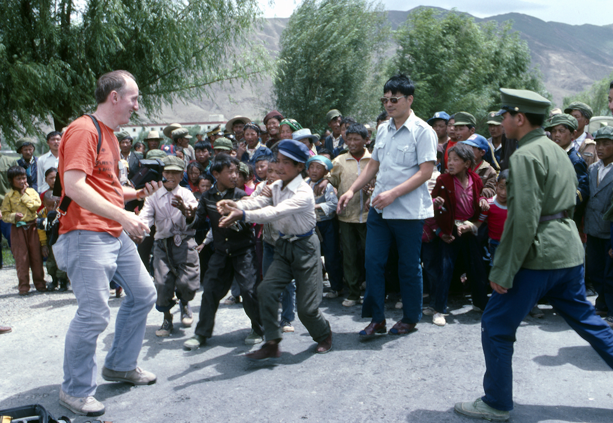 Blast From The Past - Early 1990 - This is a photo of me in the high mountains of Tibet, China on a photo assignment to cover the airlifting of a Sikorsky Helicopter by way of a USAF C-5 Aircraft. I took a Polaroid Instant Camera with me and used it to take pictures of the local residents. Here I had just photographed a group of kids and they were all clamoring for the picture. Can't recall which one got this picture, but I did a bunch more till all the film was gone. The kids thought it was magic to watch the photo develop before their eyes, as did many of the other folks! This was my second and final trip to China before I retired from the Air Force.