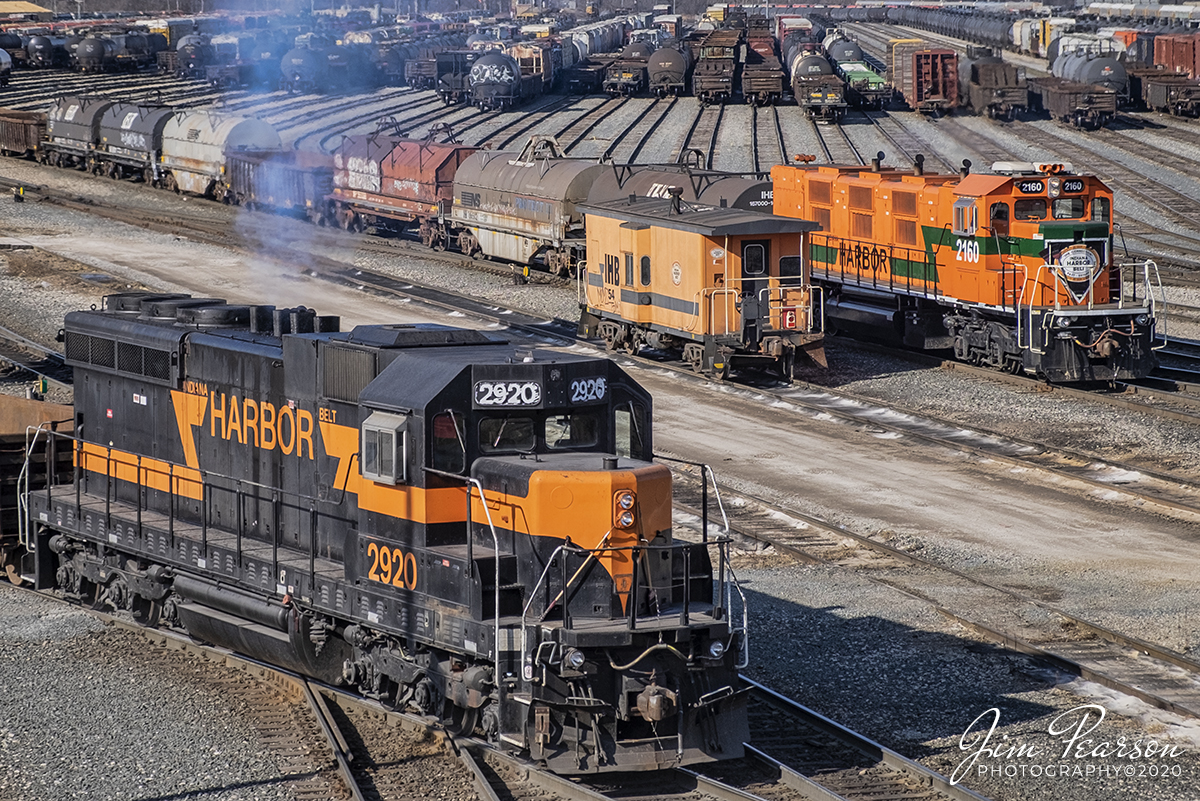 February 22, 2020 - Indiana Harbor Belt 2920 backs into the Blue Island Rail Yard at Riverdale, IL as IHB 2160 works it's own job during a cold winters morning as IHB caboose 54 sits waiting to be the shoving platform on its next assignment.

According to the IHB Website: The Indiana Harbor Belt Railroad is the largest switch carrier in the U.S. with 54 miles of mainline track (24 miles of which is double main track) and 266 miles of additional yard and siding track.

The IHB provides a wide variety of services, including industrial switching with 160 customers, generating 170,000 carloads of business annually. The IHB interchanges daily with 16 other rail carriers in Chicago. A growing fleet of approximately 1,400 freight cars is geared predominately to the steel industry. The industrial traffic base includes 4 of the 5 largest steel producers in the U.S. and a large aluminum processor, oil refineries, corn millers, grain elevators, chemical plants, warehouses, lumber transloading, and bulk transfer operations. IHB's industrial traffic consists of 38% primary metals, 12% chemicals & petroleum products, 11% food products, 8% scrap iron, 7% coal & coke, 6% whole grain, as well as a variety of other products including lumber, paper, and aggregates. The IHB also operates as an intermediate switch carrier between the 12 trunk-line railroads for traffic interchanged between them in Chicago, generating an additional 475,000 revenue cars.

The IHB main line circles Chicago from near O'Hare to Northwest Indiana and roughly parallels Interstate 294 (Tri-state Expressway) and I-80/94. Its primary yard, Blue Island (a 44 class track hump yard) at Riverdale, IL lies in about the center of the railroad. Other major yards includes Gibson (in Hammond, IN) which only classifies cars of new autos and Michigan Avenue Yard (in East Chicago) which serves the extensive steel plants which accounts for IHB's primary business. From East Chicago, the IHB operates east for an additional 16 miles on trackage rights to access Burns Harbor, IN and Portage, IN, which includes Indiana's International Port.