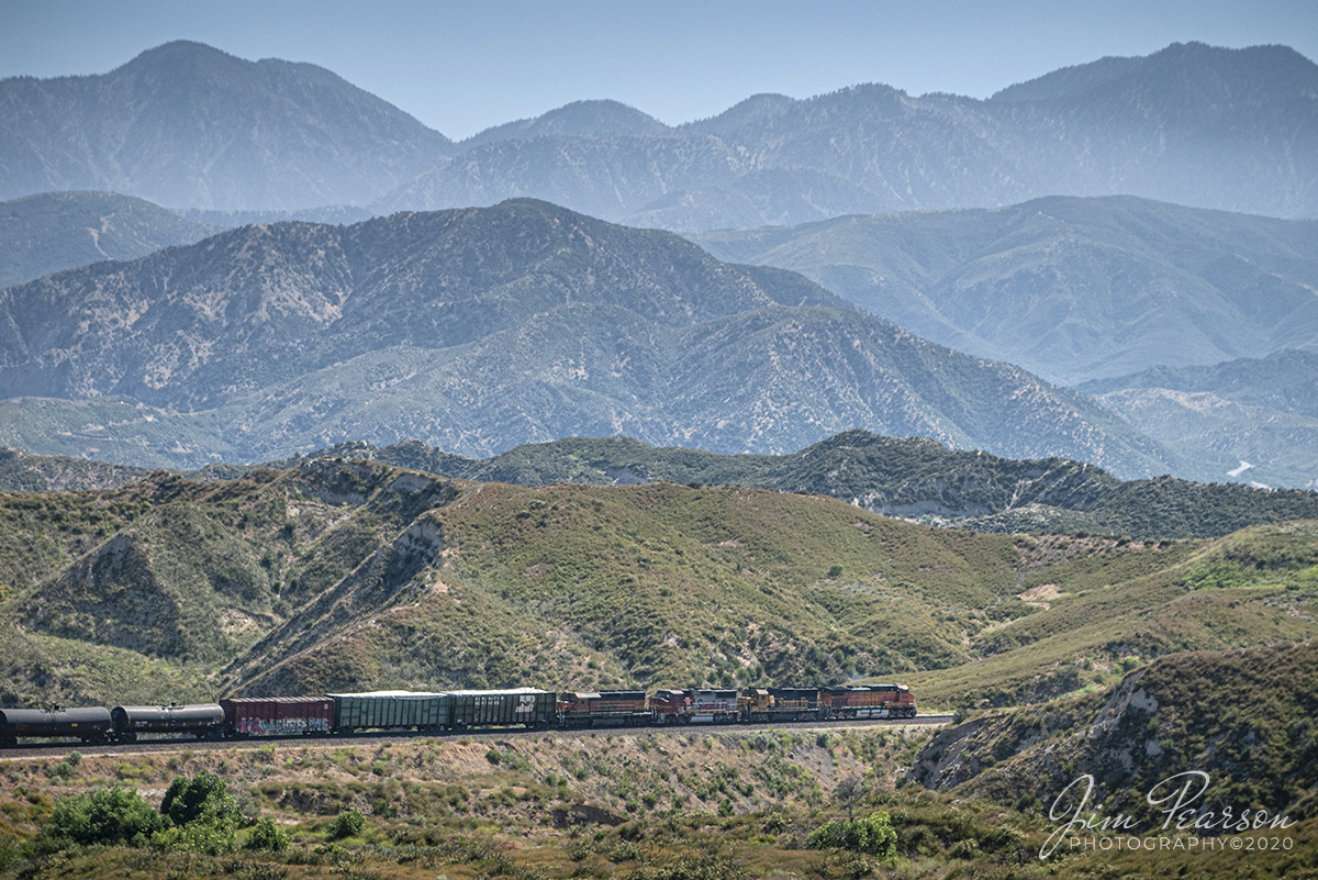 June 19, 2006 - Blast From The Past - BNSF 5294, 8732, 158 and 7334, each in a different paint scheme, make for a rainbow of colors as the lead a manifest down the Cajon Pass in southern California.