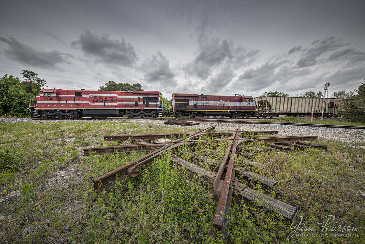 May 15, 2020 - Today I spent trackside with fellow railfan Cooper Smith, where he navigated me through some of his favorite spots in west Tennessee. I'd been here before back on New Years Day, but only caught 1 train moving on the trip. Today was a lot different as just about everywhere we went, a train showed up shortly after we got there!

One of our goals was to catch the West Tennessee Railroad (WTNN) working somewhere in the area and we found their Fulton Turn (T92) crossing the WTNN/CSX Diamond at Milan, Tennessee as 5543 and 4071 lead the way south back to their yard at Jackson, TN past the old diamond sitting in the grass. A good day trackside and a big shout out to those that provided train updates and locations!

According to their website: The West Tennessee Railroad began in 1984 on a portion of the former Mobile & Ohio Railroad main line between Jackson and Kenton, Tennessee.  In 2001, the WTNN expanded operations, acquiring operating rights over the former ICG line between Corinth, Mississippi and Fulton, Kentucky.

WTNN operates on a daily basis and has interchanges with CSX, KCS, NS, and CN.  Car storage and transloading services are provided in several convenient areas along the WTNN line.

Tech Info: Nikon D800, RAW, Irex 11mm lens, 1/800 sec, f/11, ISO 125.