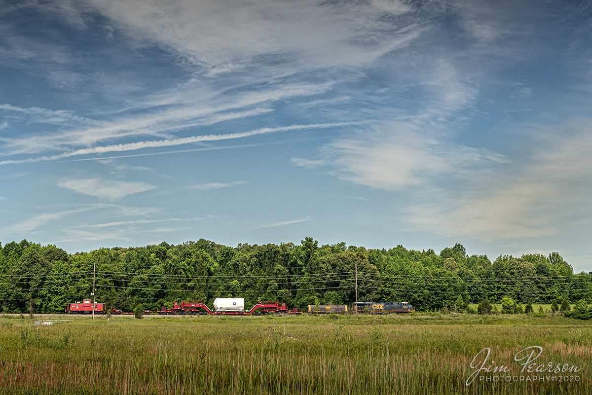 June 3, 2020 - Kasgro (KRL) Caboose 073 brings up the rear of CSX W993-31, with CSXT 5263 leading, as it approaches East Diamond on the cut off at Madisonville, Kentucky as it heads north on the Henderson Subdivision. The train was running with a load for General Electric on a Kasgro 20 Axel Depressed Deck Car KRL 204040 that has a load limit of 943,900lbs.

Kasgro Rail Corporation builds, maintains, and manages a fleet of nearly 500 specialty railcars which are used for transporting oversized and heavy "dimensional" loads anywhere in the United States Railroad system.

Tech Info: Nikon D800, RAW, Sigma 25-70 @ 40mm, f/10, 1/800 sec, ISO 400.