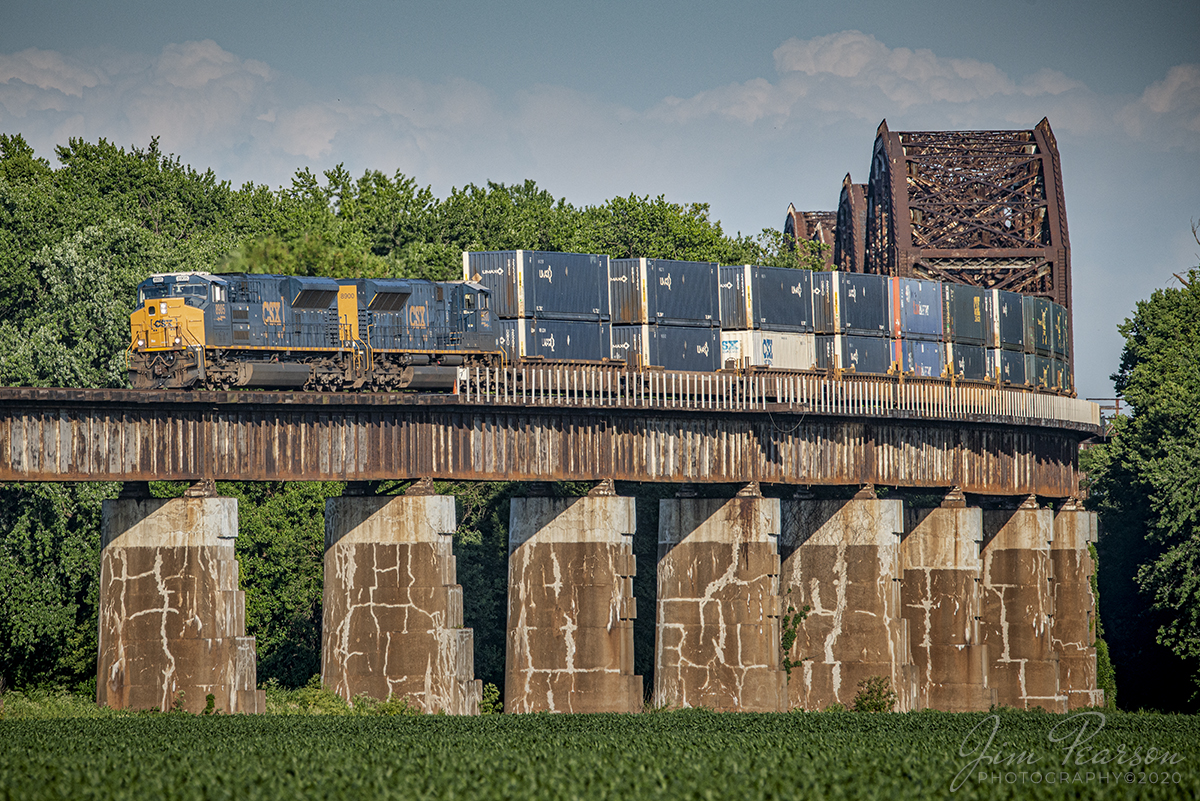 June 13, 2020 - CSX Intermodal Q026-12 starts its descent down the viaduct at Rahm, Indiana, with two of CSX's newer ST70AH Tier 4 locomotives, 8905 and 8900 leading, as they head north over the Ohio River Bridge on the Henderson Subdivision toward Evansville, Indiana.

Tech Info: Nikon D800, RAW, Sigma 150-600 @ 420mm, f/8, 1/1000sec, ISO 360.