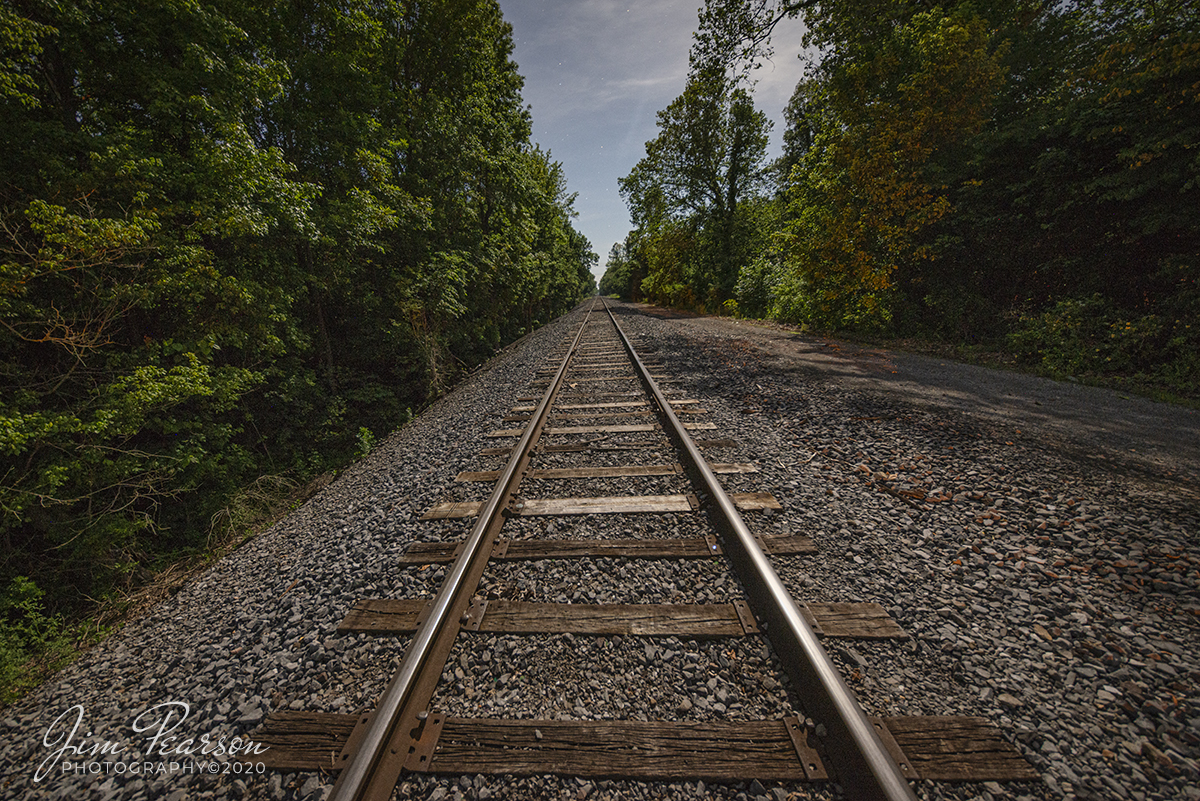 June 2, 2020 - It was the dead of night, crickets, frogs and an occasional car passing through the crossing breaking the silence at the Rosewood Crossing, as the moon illuminated the tracks headed out of the south end of the Paducah and Louisville Railway at Paducah, Kentucky toward Mayfield. Moonlight provides a mystical light in my opinion. 

Tech Info: Full Frame Nikon D800, RAW, Irex 11mn, f/5, 30 seconds, +2 stops, ISO 640 on a Gitzo Tripod, camera timer, 3 second delay, Mirror Locked up.