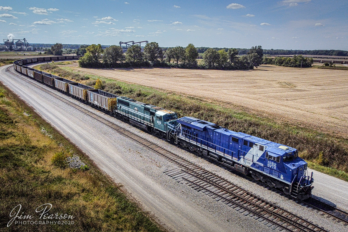 October 3, 2020  SavaTrans (SVTX) 1982 and Evansville Western Railway 4519 wait for a fresh crew as they head up an empty coal train after unloading at the Dock at West Franklin, Indiana. The Chris Cline Group are owners of the company Savatrans which purchased three ES44AC locomotives numbered to represent the Penn State Championship football years # 1912, 1982, & 1986. The company operates from Sugar Camp Mine in Akin, IL to Abee, IN near Mount Vernon/West Franklin, IN area.

Tech Info: DJI Mavic Mini Drone, JPG, 4.5mm (24mm equivalent lens) f/2.8, 1/4000, ISO 100.