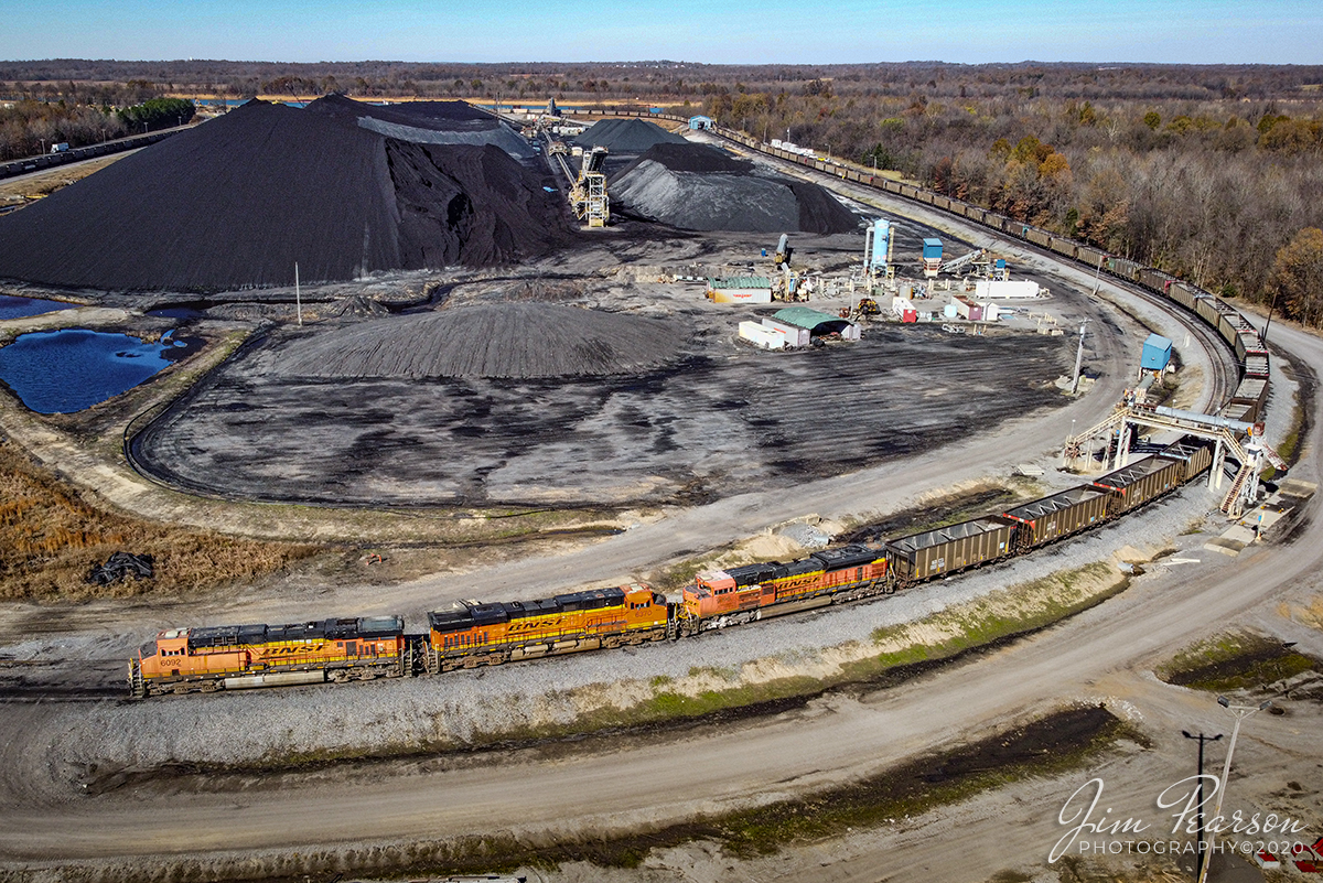 Waiting on a fresh crew at Calvert City, Ky

On November 17th, 2020 BNSF 6092, 6370 and 9196 head up empty coal drag SPC1 as it sits in the loop at Calvert City Terminal waiting for a fresh crew from the Paducah and Louisville Railway to ferry the train back to their yard at Paducah, Kentucky. There a fresh BNSF crew will pickup the train and take it on north for another load of coal.

Tech Info: DJI Mavic Mini Drone, JPG, 4.5mm (24mm equivalent lens) f/2.8, 1/800, ISO 100.