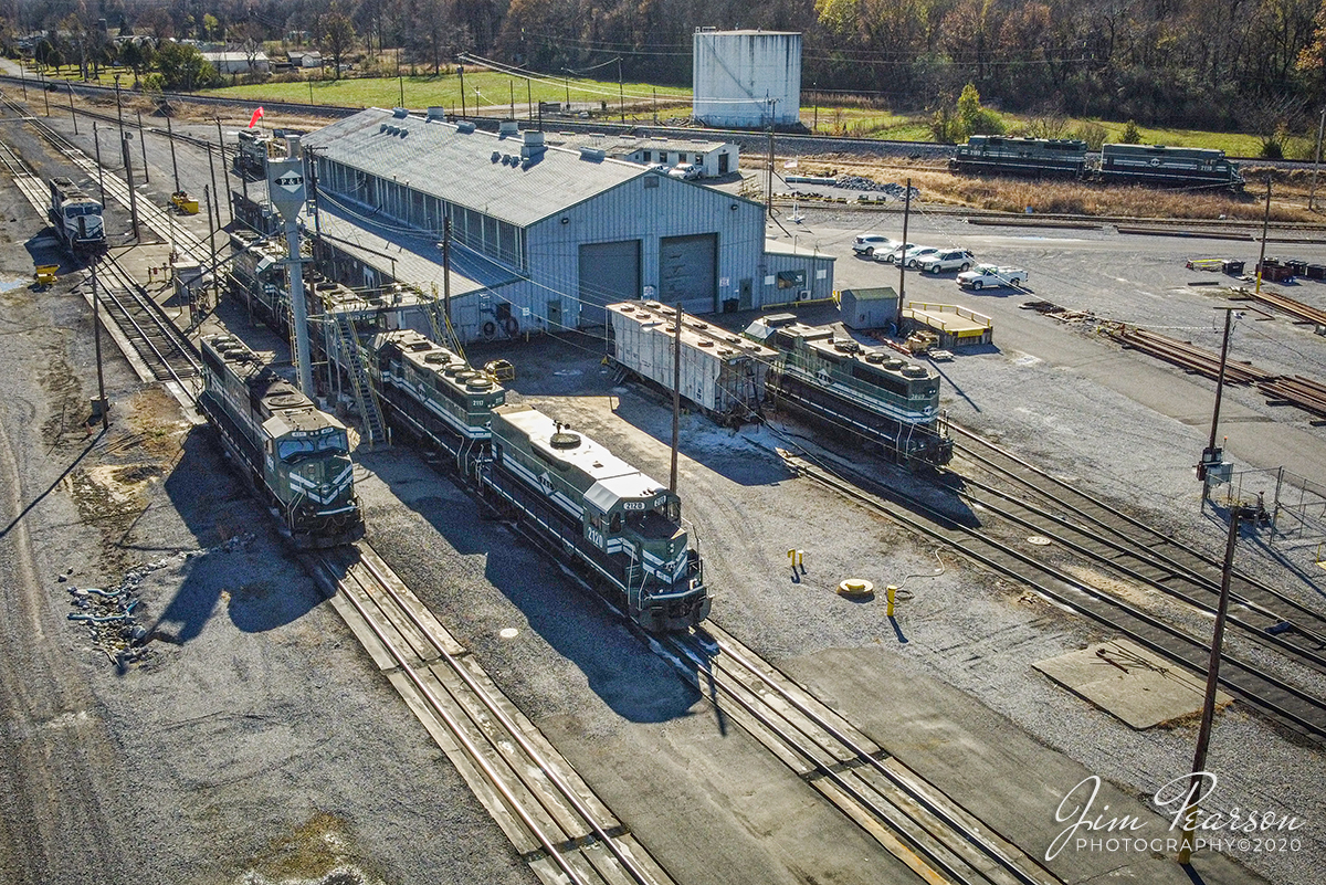 Paducah and Louisville Railway Shops

A mixture of power sits around the shop area at the Paducah and Louisville Railway shop in Paducah, Kentucky.

According to Wikipedia: The Paducah & Louisville Railway (reporting mark PAL) is a Class II railroad that operates freight service between Paducah and Louisville, Kentucky. The line is located entirely within the Commonwealth of Kentucky.

The 270-mile (430 km) line was purchased from Illinois Central Gulf Railroad in August, 1986. The 223-mile (359 km) main route runs between Paducah and Louisville with branch lines from Paducah to Kevil and Mayfield, Kentucky and another from Cecilia to Elizabethtown, Kentucky. The PAL interchanges with Burlington Northern Santa Fe (BNSF) and Canadian National (CN), formerly Illinois Central Railroad, in Paducah. In Madisonville, the line interchanges with CSX Transportation (CSXT).

In Louisville, the line interchanges with the Indiana Rail Road (INRD), CSX Transportation (CSXT) and Norfolk Southern (NS). Class III line connections are at Princeton with the Fredonia Valley Railroad (FVRR) and at Louisville with the Louisville and Indiana Railroad (LIRC). The line today carries over 200,000 carloads of traffic on a CTC-controlled mainline with welded rail and even a section of double track nearly 20 miles (32 km) long between Paducah and just east of Calvert City. This is a huge improvement from the little amount of traffic and poor condition the line was in by the time the ICG had sold it.

Today it is a big regional class II railroad connecting with four class I railroads (listed above), as well as the three shortline connections it makes which are also listed above. It has 270 route-miles of track, of which 233 miles (375 km) are its mainline running between its namesake towns of Paducah and Louisville, as well as branch lines to Mayfield, Kevil, and Elizabethtown. The railroad serves "many chemical plants and other manufacturing companies, several coal mines, numerous clay and stone quarries, lumber and propane distributors, farm [including a few large grain elevators] and mine equipment suppliers, warehouses, transloads, bulk terminals, riverports, and one military base."

The parent company of the PAL, P&L Transportation, also operates the Evansville Western Railway and the Appalachian and Ohio Railroad.

Tech Info: DJI Mavic Mini Drone, JPG, 4.5mm (24mm equivalent lens) f/2.8, 1/1000, ISO 100.