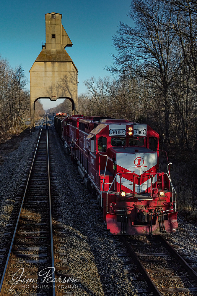 Indiana Railroad Interchanges with CSX at Sullivan, Indiana

Indiana Railroads (INRD) 3002 leads the Hiawatha-Palestine turn HWPAT-05 sits under the old C&EI coaling tower that was built in 1941 to service steam locomotives, at Sullivan, Indiana as it's conductors connects the train to a string of cars from CSX on the CE&D Subdivision before continuing it's run to Palestine, Illinois on December 5th, 2020.

According to Wikipedia: The Indiana Rail Road (reporting mark INRD) is a United States Class II railroad, originally operating over former Illinois Central Railroad trackage from Newton, Illinois, to Indianapolis, Indiana, a distance of 155 miles.

This line, now known as the Indiana Rail Roads Indianapolis Subdivision, comprises most of the former IC line from Indianapolis to Effingham, Illinois; Illinois Central successor Canadian National Railway retains the portion from Newton to Effingham. INRD also owns a former Milwaukee Road line from Terre Haute, Indiana, to Burns City, Indiana (site of the Crane Naval Surface Warfare Center), with trackage rights extending to Chicago, Illinois. INRD serves Louisville, Kentucky, and the Port of Indiana on the Ohio River at Jeffersonville, Indiana, through a haulage agreement with the Louisville & Indiana Railroad (LIRC).