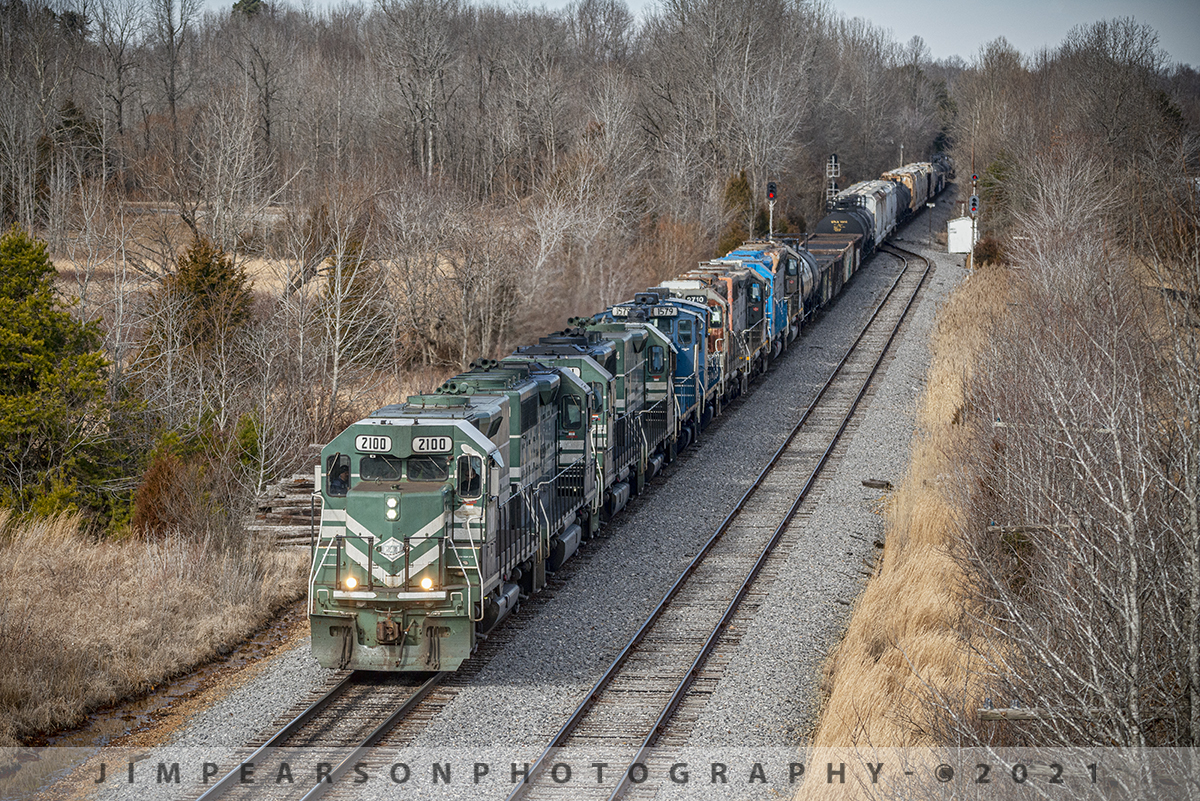 Power move on the Paducah and Louisville Railway at Dawson Springs, Ky

Paducah and Louisville Railway 2100 leads the daily local south, approaching the US 62 overpass after making it's pickup from CSX at Atkinson Yard in Madisonville, Kentucky. Part of it's pickup on January 18th, 2021, was six engines, dead in tow, bound for the National Railway Equipment shops in Paducah, Kentucky.

The power on this train was, PAL, 2100, 2121, 2101, 2104, dead in tow were, CIT/CBFX 1579, 1589 switchers, NERX 2710, 8580 (both ex SP), Northside Mining 2001 and NREX 2724, also ex-SP.

Tech Info: Nikon D800, RAW, Sigma 150-600 @ 150mm, f/5, 1/3200, ISO 640.