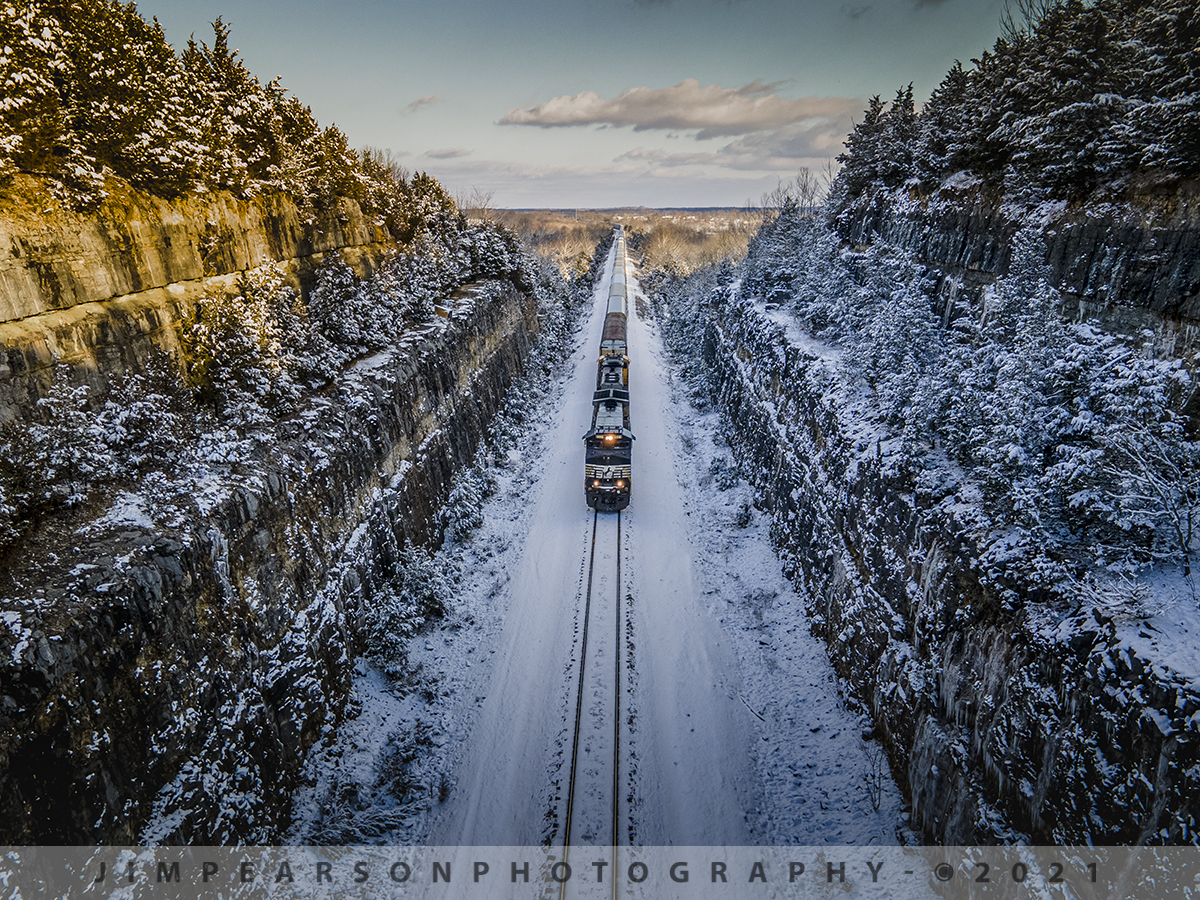 Norfolk Southern Sonic Bonnets on the move

Norfolk Southern 4004 and 1800, the Black and Yellow "Sonic Bonnets" lead NS empty autorack train 124 west as they chase the setting sun through the cut at Tunnel Hill Road, just west of Ramsey, Indiana as the light snowfall from the day before provides a nice dusting for this peaceful winter scene on the NS Southern-East District. 

Tech Info: DJI Mavic Air 2 Drone, RAW, 4.5mm (24mm equivalent lens) f/2.8, 1/250, ISO 100.