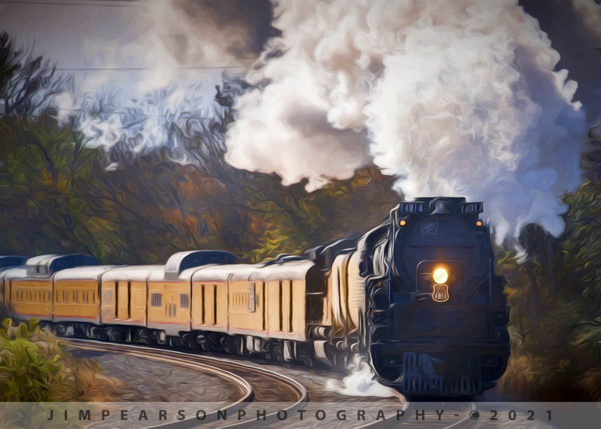 November 13, 2019 - UP engineer Ed Dickens leans out the cab of Union Pacific 4014 Big Boy as it heads through the curve approaching Malvern, Arkansas, as it races north on the Little Rock Subdivision with it's passenger train on UP's Race Across the Southwest event. 

According to Union Pacific's Website: Twenty-five Big Boys were built exclusively for Union Pacific Railroad, the first of which was delivered in 1941. The locomotives were 132 feet long and weighed 1.2 million pounds. Because of their great length, the frames of the Big Boys were "hinged," or articulated, to allow them to negotiate curves. They had a 4-8-8-4 wheel arrangement, which meant they had four wheels on the leading set of "pilot" wheels which guided the engine, eight drivers, another set of eight drivers, and four wheels following which supported the rear of the locomotive. The massive engines normally operated between Ogden, Utah, and Cheyenne, Wyo.

There are seven Big Boys on public display in various cities around the country. They can be found in St. Louis, Missouri; Dallas, Texas; Omaha, Nebraska; Denver, Colorado; Scranton, Pennsylvania; Green Bay, Wisconsin; and Cheyenne, Wyoming.

Big Boy No. 4014 was delivered to Union Pacific in December 1941. The locomotive was retired in December 1961, having traveled 1,031,205 miles in its 20 years in service.  Union Pacific reacquired No. 4014 from the RailGiants Museum in Pomona, California, in 2013, and relocated it back to Cheyenne to begin a multi-year restoration process. It returned to service in May 2019 to celebrate the 150th Anniversary of the Transcontinental Railroad's Completion.