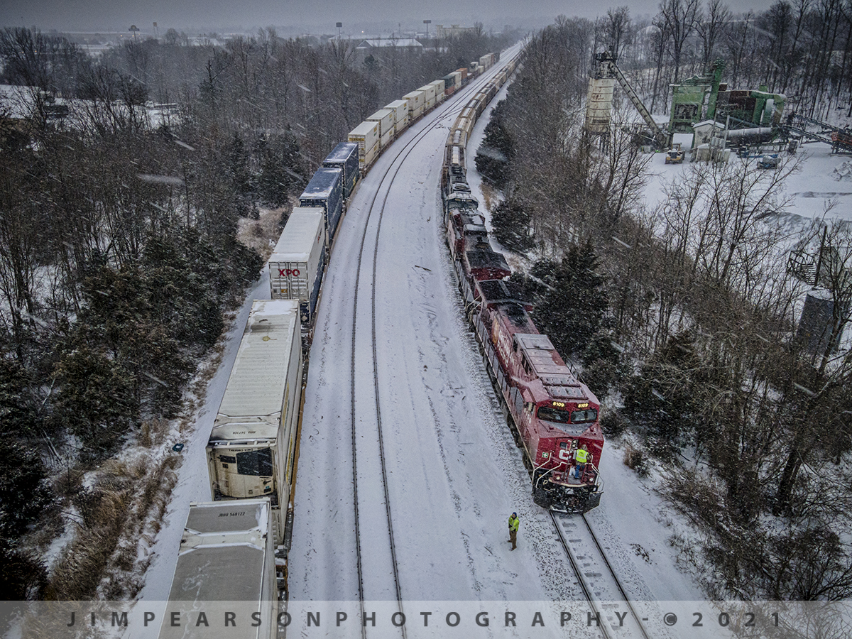 A snowy meet at Arklow, Madisonville, Ky

As the last light of the day fades the crew on board CSX K814 braves the cold, winter's snow as they step to the ground from Canadian Pacific 8109 at Arklow, to conduct a roll-by inspection of hot intermodal Q029 as it heads south on the Henderson Subdivision at Madisonville, Kentucky.

CSX Q029 is usually an early morning move, but due to the winter storms that blew through the region, it along with many other trains moved a lot slower than usual with the conditions making it harder for the crews getting their trains loaded and moving.

Tech Info: DJI Mavic Air 2 Drone, RAW, 4.5mm (24mm equivalent lens) f/2.8, 1/160, ISO 400.