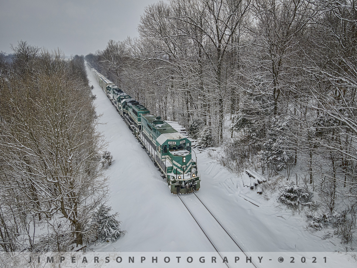 PAL 2104 Dashing through the Snow!

The Princeton to Madisonville, Ky Paducah and Louisville Railway local dashes through the snow past the backside of my property on the right as it heads north at Richland, Kentucky through the freshly fallen snow!

We got probably another 3-5 inches of fresh snow this morning, February 18th, 2021, and while listening to my scanner and trying to decide if I wanted to venture down off the hill at my home I heard the Paducah and Louisville Railway local getting track warrants about 3 miles from the house.

I put on my boots and went dashing through the snow to put my drone up before it got to me and grabbed this shot of PAL 2104, 2101, 2121 and 2112 leading. 

At Madisonville they'll do their interchange work in the cold frigid weather with CSX at Atkinson Yard, dropping of these cars and picking up others! 

A scene repeated all around the country on various railroads, by dedicated railroaders! Hats off to all the crews that run during frigid weather like this and all the behind the scenes folks that make it all happen!

Tech Info: DJI Mavic Air 2 Drone, RAW, 4.5mm (24mm equivalent lens) f/2.8, 1/320, ISO 100.