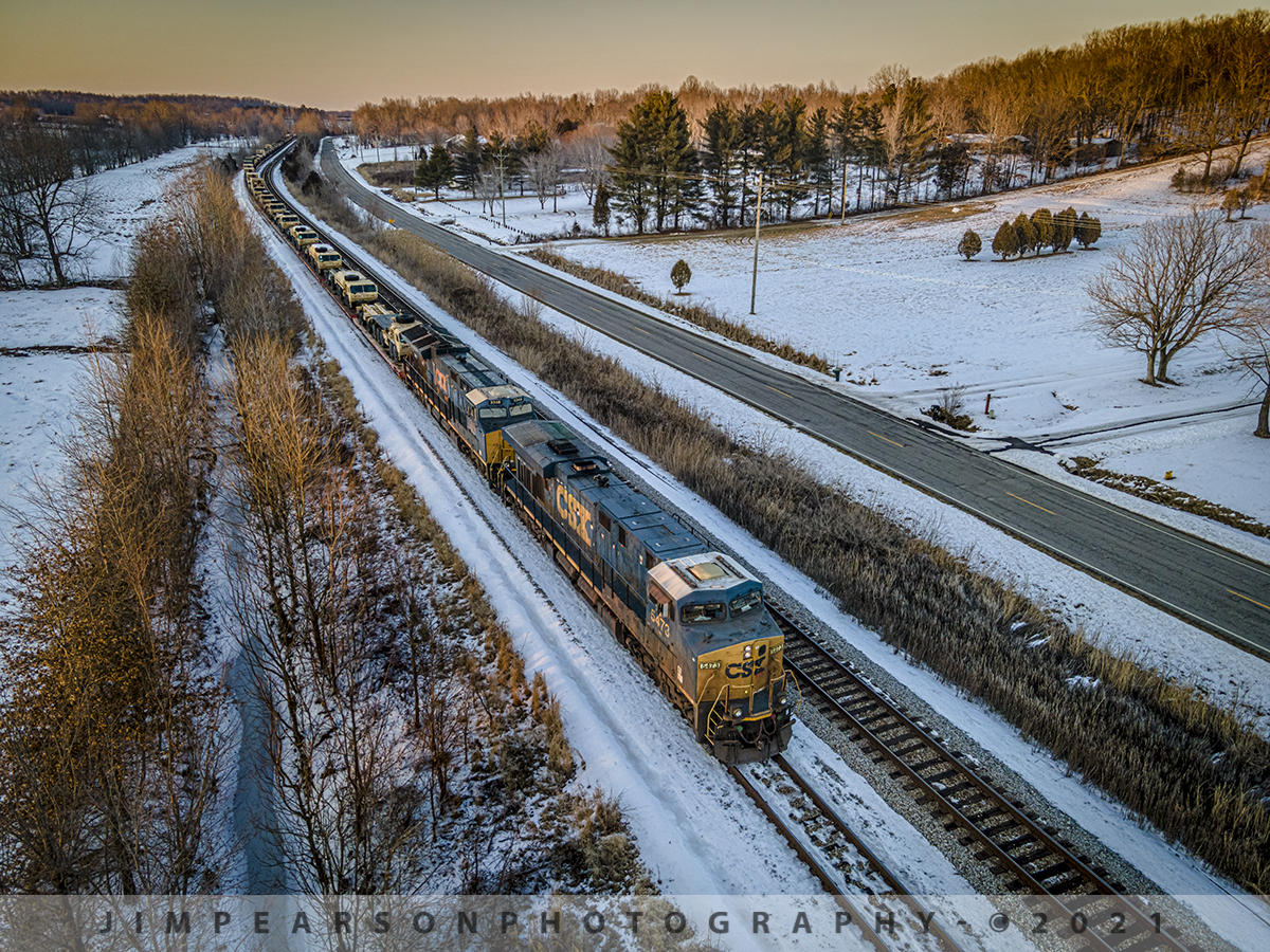 Southbound military move waiting at sunset

I got a heads up on this military move from a fellow railfan and friend Travis Collins as CSX W809 headed south from up in Indiana around 10am on February 20th, 2021 on the CSX CE&D Subdivision. 

I kept up with its movement through southern Indiana via Facebook and fellow railfans that were out along the lines and tracked its progress in spits and starts along the way where it head to wait for higher priority trains that were moving north.

After stopping at Howell yard in Evansville, Indiana it finally made its way onto the CSX Henderson Subdivision after taking on fuel and making a crew change at Howell, but by this time those of us waiting for it to make its appearance were starting to worry that we'd lose our light before it made it to where 7 of us railfans were waiting for it at Mortons Junction in Mortons Gap, Kentucky.

That's where they put it on the cutoff that bypasses Madisonville and Earlington where it sat behind a loaded coal train to wait for hot intermodal Q028 and an empty coal drag to pass on the main at the junction. 

Finally the loaded coal train headed south and I knew the military move would be next and I decided to move on down to the south end of Nortonville where I hoped I would get some light on the train as by this time it was just about sunset.

Here we find the train where it finally crawled to a stop just south of Nortonville with CSXT 5473 and 3348 leading the 5,000+ load of military vehicles elephant style to wait for another northbound Q648. This meet worked really well for my shot since the train came to a full stop and I was able to shoot with a slow shutterspeed to keep my ISO and noise down from the low light scene as the last rays of light swept across the valley!

Patience pays off in the long run! 

Tech Info: DJI Mavic Air 2 Drone, RAW, 4.5mm (24mm equivalent lens) f/2.8, 1/80, ISO 100.