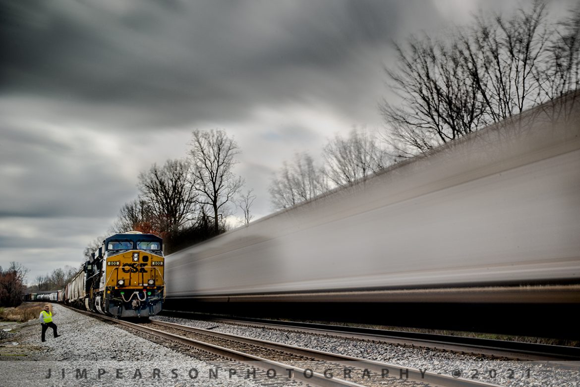 Roll-by inspection of CSX Q025-18 at Slaughters, Ky

One of two (the other stood out of frame) crew members from CSX X584 watch on the ground from the siding as hot intermodal CSX Q025-18 zips past their train at the north end of the siding at Slaughters, Kentucky as it heads south on the Henderson Subdivision on March 18th, 2021.

Not sure why X584 was on the Henderson Subdivision as it normally runs between Wauhatchi, TN  Wild Creek, AL and neither is anywhere near here. I'm assuming it was due to flooding somewhere.

I'm working on combining a new technique here that I've been learning that is called Long Exposure photography, which is where using a neutral density filter and with the camera on a tripod. 

I used a long exposure to achieve the effect of the world moving along at a fast pace, but also keeping some things rooted in place! I did a series of about six exposures as the train passed and fortunately the crew member stood still during the 30 seconds it took to make this shot. Tech details below.

Tech Info: Nikon D800, RAW, Sigma 24-70 @52mm f/32, 30 seconds, ISO 50, exposure delay mode, rear eyepiece closed during exposure, camera on a Manfroto tripod, 16 stop ND Filter.