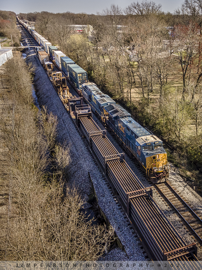 Traffic flowing again after a dispatcher's nightmare

Looking at this photograph of hot intermodal CSX Q026 passing a tied down CSX W017 rail train just north of the yard at Guthrie, Kentucky on the Henderson Subdivision, you wouldnt know what transpired over 7 hours before their arrivals here! Well, heres what happened!

On March 20th, 2021 at approximately 9am CSX Q513 (12,000+ feet long) was about halfway through Adams, Tennessee when their train ripped a coupler completely out of a refrigerated car about 2/3 through their train and went into full emergency, which ended up causing a major problem on the Henderson Subdivision!

Since the train separated on the main, nothing could get around it and before it was over all four hot intermodals on the Henderson Subdivision, Q029, Q025, Q026 and Q028, were now delayed, as were many other trains, including this rail train as a result!

They finally figured out a plan that worked where the power from Q029 was brought up from Guthrie, Ky and hooked onto the rear of Q513 to hold the last 1/3 of Q513 in place. 

Q513 then pulled the front 2/3 of their train south into the siding at Cedar Hill, Tennessee where a bracket was welded onto the reefer car, to hold the EOT device, as a new coupler couldnt be installed due to the damage.

The power on Q513 then pulled away from its train at Cedar Hill, where it went out the south end of the siding and back north on the main to pickup the rest of its train. 

They then brought the rest of Q513 back to Cedar Hill where they backed into the siding and hooked onto the rest of their train. By this time the crew was now out of time and they the train down, till a fresh crew showed up later to take it on south.

Finally, Q029, Q025 and loaded a loaded coal train went on south where Q026 and Q028 were waiting to come north, and the railroad got to moving again!

As a result of all this, the rail train, which sat at the south end of Trenton, Ky for all this time, ended up being brought on up to Guthrie where their train was also tied down just short of the crossing at Park Street. 

The crew was sent to a hotel and Im not sure if its because they ran out of time or if the dispatcher didnt want a slow speed train (30mp train and 10mph through turnouts and sidings) on the line as everything had been backing up for six hours! 

Just another day on the railroad!!

Tech Info: DJI Mavic Air 2 Drone, RAW, 4.5mm (24mm equivalent lens) f/2.8, 1/500, ISO 100.