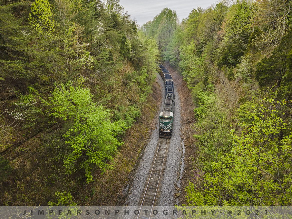 Northbound Paducah and Louisville Railway LG1 at Rosine, Ky

Paducah and Louisville Railway 4516 and 2012 lead a loaded Louisville Gas and Electric (LG1) loaded coal train through the cut just north of Rosine, Kentucky as it makes its way toward Louisville on April 14th, 2021.

According to Wikipedia: The Paducah & Louisville Railway is a Class II railroad that operates freight service between Paducah and Louisville, Kentucky. The line is located entirely within the Commonwealth of Kentucky. The 270-mile line was purchased from Illinois Central Gulf Railroad in August 1986.

Tech Info: DJI Mavic Air 2 Drone, RAW, 4.5mm (24mm equivalent lens) f/2.8, 1/160, ISO 100.