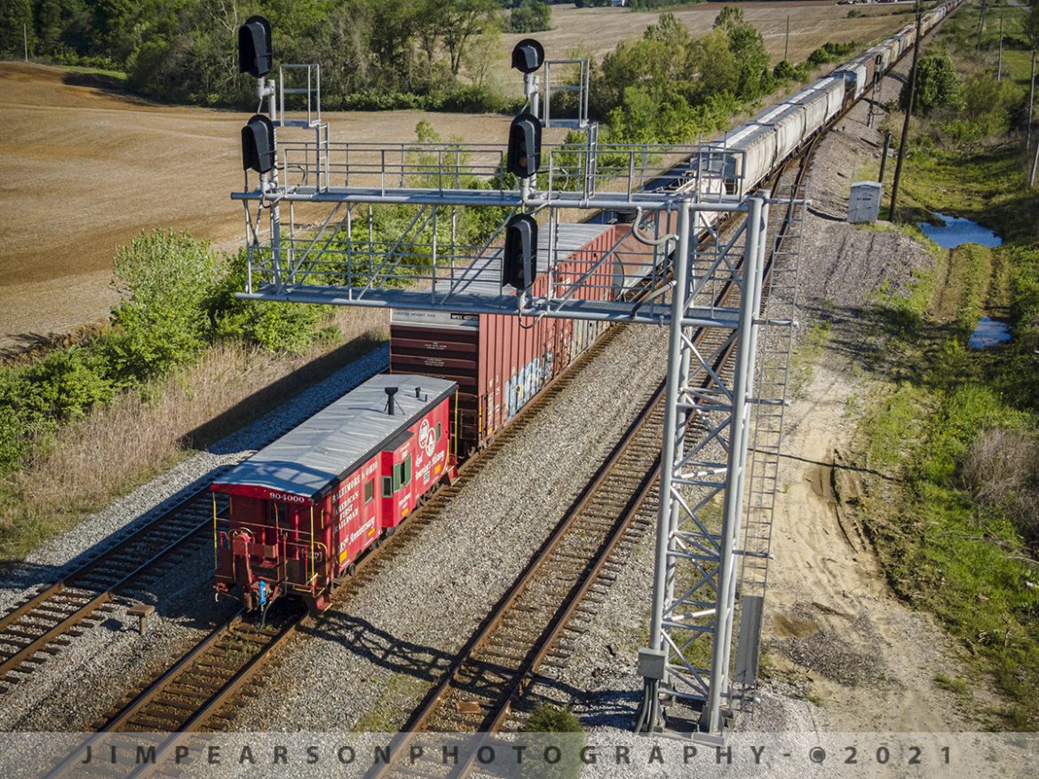 B&O 185th Anniversary Caboose northbound at Princeton, Indiana

Just something you don't see much these days is a caboose on the end of a train, such as here where the B&Q 185th Anniversary Caboose bringing up the rear of CSX Q0648 as it passes the signal at the north end of Dugger Siding at Princeton, Indiana on the CSX CE&D Subdivision on May 1st, 2021.

I still remember as clear as day the times when this was an everyday occurrence and even manned with a crew, but today, it's a rare occurrence and almost never with a crew. Mostly they're in museums or used as shoving platforms for a crew when they're working a yard or industrial complex that requires the conductor to ride on the end of the train as the engine shoves the train.

According to Wikipedia: A caboose is a manned North American railroad car coupled at the end of a freight train. Cabooses provide shelter for crew at the end of a train, who were formerly required in switching and shunting, keeping a lookout for load shifting, damage to equipment and cargo, and overheating axles.

Originally flatcars fitted with cabins or modified box cars, they later became purpose-built with projections above or to the sides of the car to allow crew to observe the train from shelter. The caboose also served as the conductor's office, and on long routes included sleeping accommodations and cooking facilities.

A similar railroad car, the brake van, was used on British and Commonwealth railways (the role has since been replaced by the crew car in Australia). On trains not fitted with continuous brakes, brake vans provided a supplementary braking system, and they helped keep chain couplings taut.

Cabooses were used on every freight train in the United States until the 1980s, when safety laws requiring the presence of cabooses and full crews were relaxed. Developments in monitoring and safety technology, such as lineside defect detectors and end-of-train devices, resulted in crew reductions and the phasing out of caboose cars. Nowadays, they are generally only used on rail maintenance or hazardous materials trains, as a platform for crew on industrial spur lines when it is required to make long reverse movements, or on heritage and tourist railroads.

Tech Info: DJI Mavic Air 2 Drone, RAW, 4.5mm (24mm equivalent lens) f/2.8, 1/800, ISO 100.