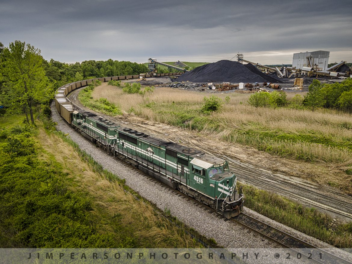 Paducah and Louisville Railway LG1 at Warrior Coal Loop, Nebo, Ky

On May 8th, 2021 Paducah and Louisville Railways 4516 and 4503 bring up the rear as DPUs on LG1 (Louisville Gas and Electric) as the last few cars pass under the loadout at Warrior Coal Mine, just outside Nebo, Kentucky. 

Once finished loading this train made its way north to the Louisville Gas and Electric power plant just outside Louisville, Ky to deliver yet another load of black gold! This train runs loaded toward Louisville every other day and the empties run on the opposite days back to Warrior Coal or Armstrong Coal at McHenry, Ky for loading.

Tech Info: DJI Mavic Air 2 Drone, RAW, 4.5mm (24mm equivalent lens) f/2.8, 1/160, ISO 100.
