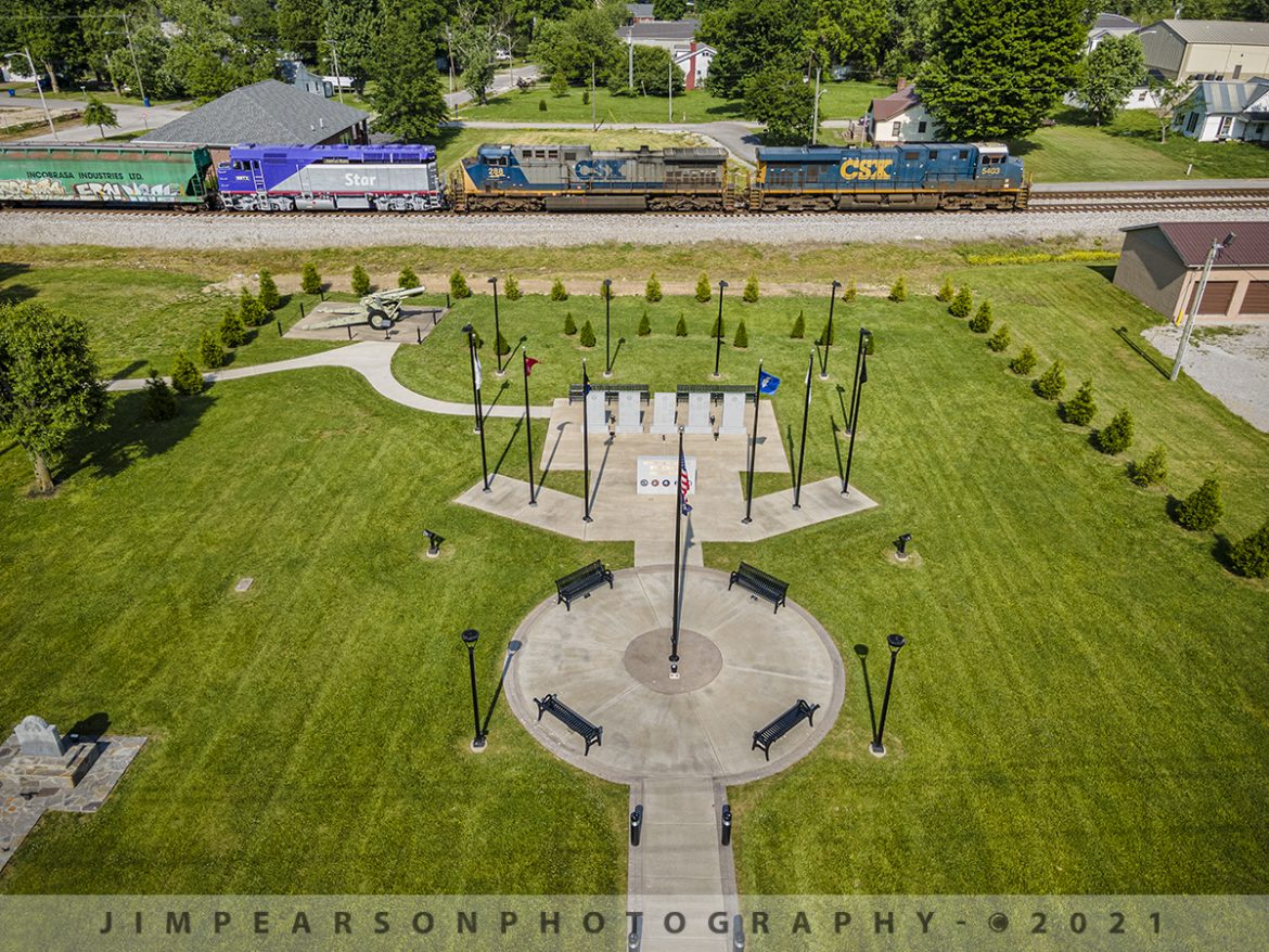 CSX Q513 Southbound passing the North Christian Veteran's Memorial Park at Crofton, Ky.

Music City Star NRTX 121 (Ex Amtrak F40PH 398) trails on CSX Q513-22 as it passes the North Christian Veterans Memorial Park at Crofton, Ky on its way back south to Nashville, Tennessee, on the Henderson Subdivision, sporting a fresh coat of paint on May 23, 2021. 

According to Wikipedia: The Music City Star is a commuter rail service running between Nashville and Lebanon, Tennessee. The service uses the existing track of the Nashville and Eastern Railroad. The line stops at seven stations: Riverfront, Donelson, Hermitage, Mt. Juliet, Martha, Hamilton Springs, and Lebanon. The operation covers 32 miles of rail line. Service began on September 18, 2006 and is owned by the Tennessee Department of Transportation.

Tech Info: DJI Mavic Air 2 Drone, RAW, 4.5mm (24mm equivalent lens) f/2.8, 1/640, ISO 100.