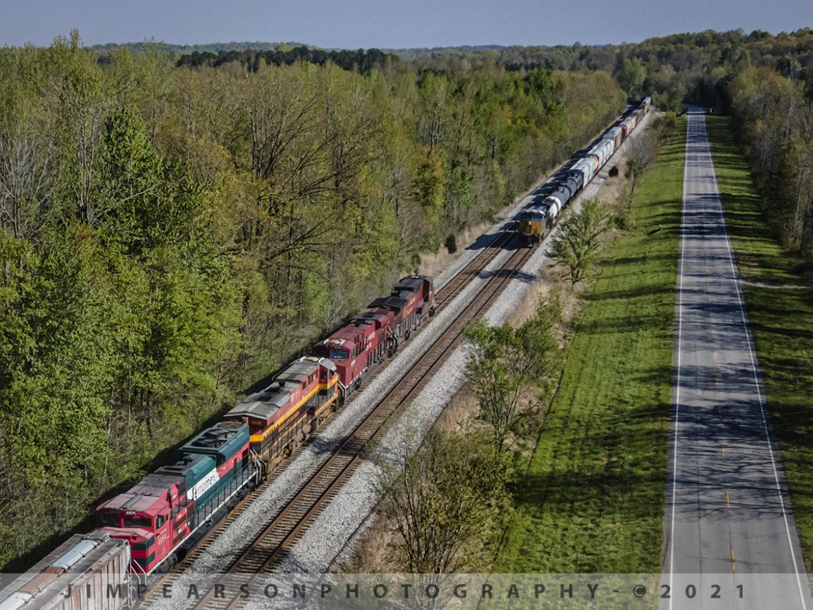 CSX K442-19 and Q513 pass each other at Nortonville, Kentucky

I love the play of shadows and the lines in this shot of CSX K442-19 and Q513 as they pass each other at Nortonville, Kentucky. CSX K442 was running with a rainbow of power consisting of Canadian Pacific 8519, 9359, Kansas City Southern 4699 and Ferromex 4054 on April 20th, 2021, along the Henderson Subdivision and prompted me to give chase.

K442 was a combined empty ethanol train, heading back north on the CSX Henderson Subdivision with a length of 12,500 feet and with that length, there were only a few places along the line between Nashville, TN, and Evansville, IN where they could meet other trains, and the two-track main between Romney and Oak Hill is one of them.

I had been following the progress of this train for a couple days and thanks to a heads up from fellow railfan Reed Reding about it being north of Nashville and then another railfan, Steve Miller that it was passing through Hopkinsville, Ky I decided it was time to get dressed (about 7:30am) and head south to find this interesting move! About 20 miles later I found it waiting in the siding at Kelly in plenty of time to catch it and then chase it back to Madisonville, catching it a few more times!

Tech Info: DJI Mavic Air 2 Drone, RAW, 4.5mm (24mm equivalent lens) f/2.8, 1/1000, ISO 100.