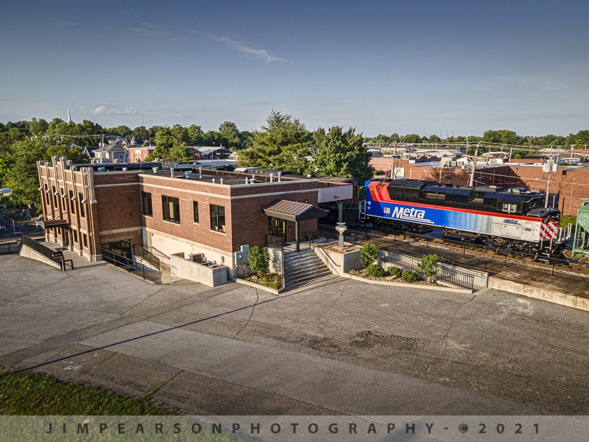 Northbound CSX 648 with Metra #97 passing L&N Depot at Madisonville, Ky

The late afternoon sunlight rakes across the scene as newly refurbished Metra passenger engine #97 trails behind CSXT 749 and 345 on CSX Q648 passes the old Louisville and Nashville Railroad Depot in downtown Madisonville, as it heads north on the CSX Henderson Subdivision on June 14th, 2021.

This depot was originally dedicated in 1929 and last saw passenger service about 1968 when L&N built an office at Atkinson Yard in Madisonville and the passenger train service was moved to that location. Currently the station is owned by the city of Madisonville and houses one of the hubs of the Kentucky Innovation Stations, which helps courageous entrepreneurs, creative business founders, high-growth startups, and savvy investors star in their own success stories. 

According to Wikipedia: Metra (reporting mark METX) is a commuter rail system in the Chicago metropolitan area serving the city of Chicago and surrounding suburbs via the Union Pacific and BNSF Railways. The system operates 242 stations on 11 rail lines. It is the fourth busiest commuter rail system in the United States by ridership and the largest and busiest commuter rail system outside the New York City metropolitan area.

Tech Info: DJI Mavic Air 2 Drone, RAW, 4.5mm (24mm equivalent lens) f/2.8, 1/400, ISO 100.