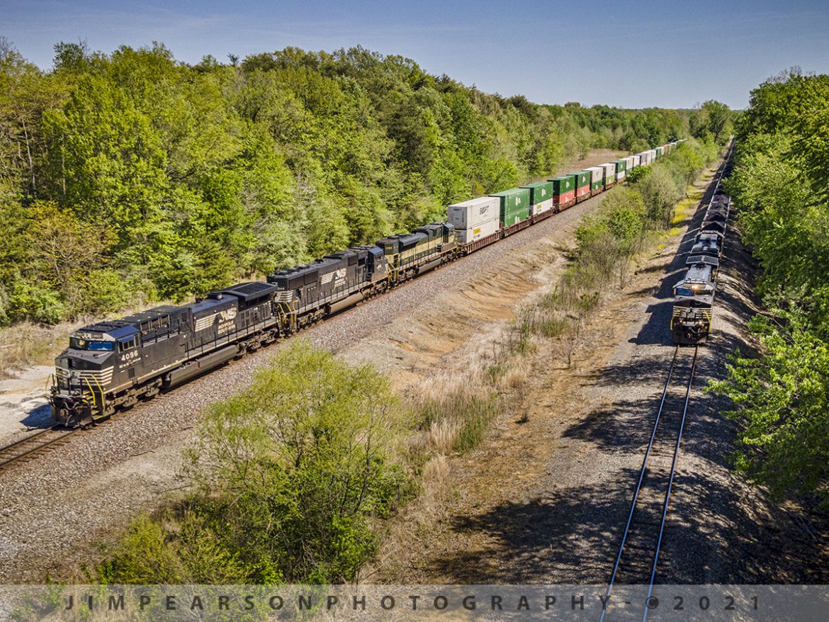 Norfolk Southern meet at Winslow, Indiana

Norfolk Southern 77J, a loaded Duke Energy coal train pulls west from the Charger mine at the HBD-DED Ayrshire just outside Winslow, Indiana as NS 224, a daily Louisville to St. Louis train, waits on the NS Southern East-West District main for it to clear Hatfield Junction on May 1st, 2021.

The lash-up on 224 is Norfolk Southern NS 4096 GE AC44C6M DC to AC Rebuilt (C40-9), NS 1844 EMD SD70ACU DC to AC Rebuilt (SD70), and NS 1068 EMD SD70ACe Erie Heritage Unit and runs daily from Louisville to St. Louis. 

Tech Info: DJI Mavic Air 2 Drone, RAW, 4.5mm (24mm equivalent lens) f/2.8, 1/800, ISO 100.