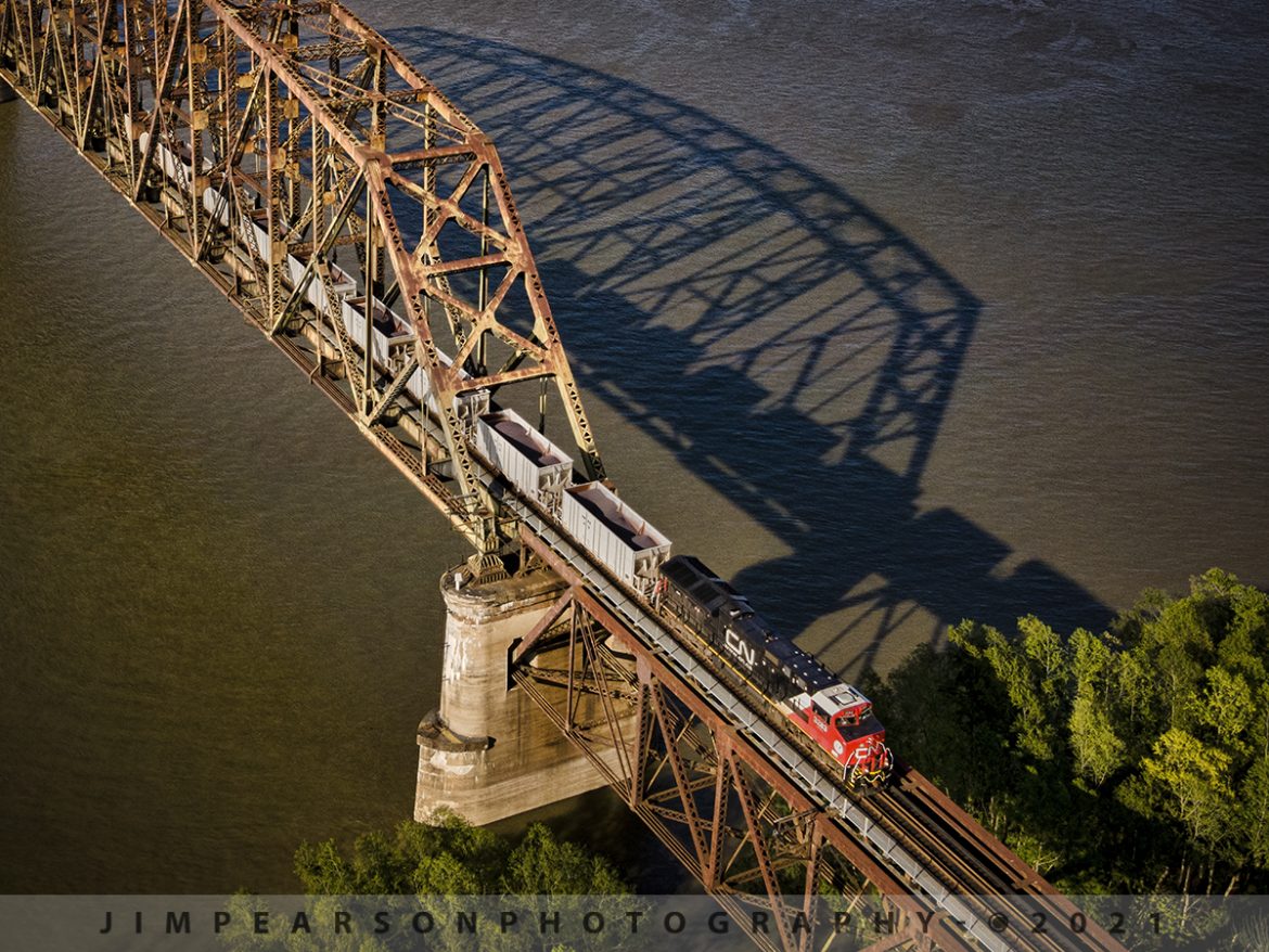 CN U72481-05 shadow move at West Paducah, KY

Canadian National U72481-05 heads southbound over the Ohio River bridge between Metropolis, IL and West Paducah, KY carrying a load of Iron ore from Keenan, MN to Convent, LA on the CN Bluford Subdivision as it and the bridge cast long and deep shadows on the waters below on May 7th, 2021.

According to Wikipedia: The Mesabi Iron Range is a mining district in northeastern Minnesota following an elongate trend containing large deposits of iron ore. It is the largest of four major iron ranges in the region collectively known as the Iron Range of Minnesota. First described in 1866, it is the chief iron ore mining district in the United States. The district is located largely in Itasca and Saint Louis counties. It has been extensively worked since 1892 and has seen a transition from high-grade direct shipping ores through gravity concentrates to the current industry exclusively producing iron ore (taconite) pellets.

There are three iron ranges in northern Minnesota, the Cuyuna, the Vermilion, and the Mesabi. Most of the world's iron ore, including that contained in northern Minnesota, was formed during the middle Precambrian period.

Tech Info: DJI Mavic Air 2 Drone, RAW, 4.5mm (24mm equivalent lens) f/2.8, 1/500, ISO 100.