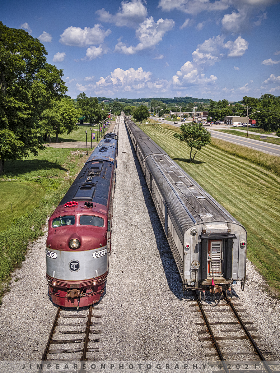 Tennessee Central 6902 runs around its train at Watertown, TN

This was my first time chasing the Tennessee Moonshine Sippin' Excursion Train from the Tennessee Central Railway Museum (TCRX), which operates out of Nashville, TN, on June 12th, 2021. While it was a hot and muggy day, me and fellow railfan Ryan Scott, of Steelrails, had a great time chasing this train from Nashville to Watertown, TN and back, along the Nashville, and Eastern Railway line. 

Here Tennessee Central Railway Museums E8 unit, 6902 runs around it's train at Watertown in preparation for their return trip to Nashville.

According to their website: EMD E8 6902 was built as New York Central 4084 in 1953. This unit would've been at the head end of many name trains of the Central's Great Steel Fleet; including the 20th Century Limited, the Empire State Express, and the Ohio State Limited, among others. The E8 (termed DPA-5e by NYC) would serve in passenger service through the Penn Central merger, and commuter service for New Jersey Transit, before settling down at the New Georgia Railroad in 1992. When the latter operation folded, a museum member purchased this unit for use on the Broadway Dinner Train, which prompted the silver and maroon colors worn today.

Since 1989, TCRM has been running passenger excursions from Nashville to points east such as Lebanon, Watertown, Baxter, Cookeville, and Monterey, Tennessee. 

Tech Info: DJI Mavic Air 2 Drone, RAW, 4.5mm (24mm equivalent lens) f/2.8, 1/1000, ISO 100.