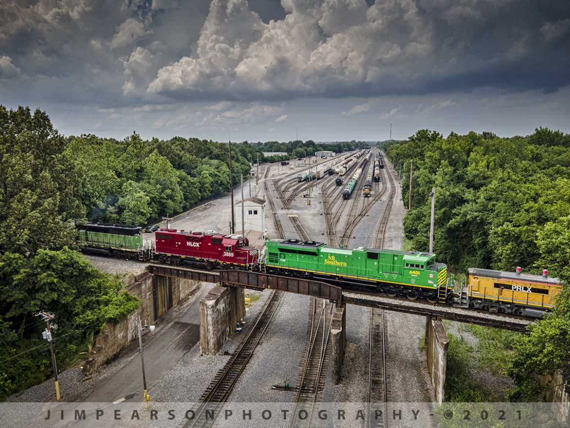 New Brunswick Southern Railway 6401 NB on BNSF local from Paducah, Ky

Newly refurbished New Brunswick Southern Railway (NBSR) 6401 trails as the third unit on the northbound Paducah to Centralia, IL BNSF local as it passes over the CN flyover at the Paducah and Louisville Railway yard in Paducah, Ky on June 30th, 2021, with PRLX switcher 1308 trailing behind it. 

Locomotive 6401 is the first of six units that are being refurbished by Progress Rail for NBSR out of Saint John, NB, Canada. The other units are 6402-6406 and they are all SD70M-2 units from what I understand. The other two units in the consist were BN 1706 leading (more photos to come on this unit) and HLCX 3889.

According to Wikipedia: The New Brunswick Southern Railway Company Limited (reporting mark NBSR) is a 131.7 mi (212.0 km) Canadian short line railway owned by the New Brunswick Railway Company Limited, a holding company that is part of "Irving Transportation Services", a division within the industrial conglomerate J.D. Irving Limited.

Tech Info for each image is in that images caption: DJI Mavic Air 2 Drone, RAW, 4.5mm (24mm equivalent lens) f/2.8, 1/1000, ISO 110.