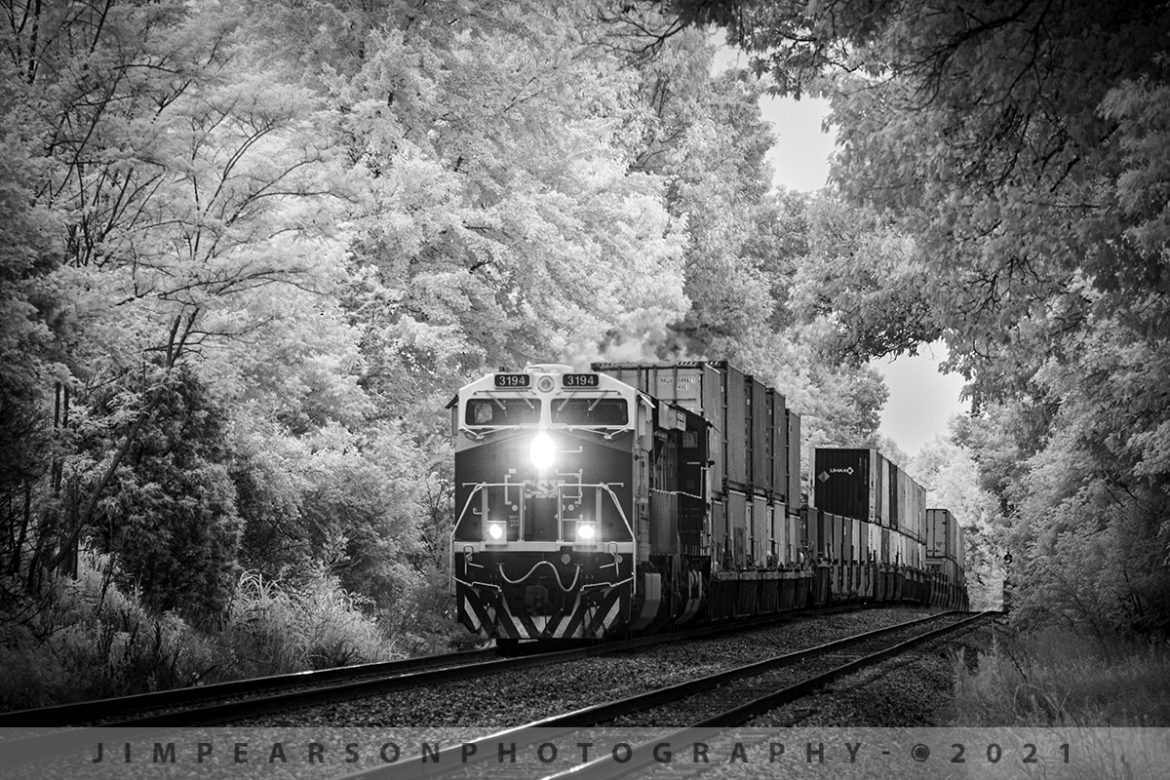 CSXT 3194 Law Enforcement Unit leads CSX Q025 SB at Hanson, KY

I don't normally railfan on Sunday mornings as I run the live broadcast of our church services, but when I got word that the CSX Law Enforcement locomotive was leading CSX Q025 I was hoping (praying) things would work out where I could get a shot of it coming through the north end of Hanson, KY on the Henderson Subdivision on July 18th, 2021. 

My church is about 5 miles from this spot, and I stopped by there early at 10am and set everything up for the live broadcast (5 iPhone Cameras) as I had reports that the train had passed through Henderson, KY at 9:50am and I got to Hanson at 10:30. Eight minutes later the train crested the hill in time for me to capture this infrared view of Q025 passing through the tunnel of trees with my converted Fuji XT-1 and able to make it back to church with 10 minutes to spare, before services began! Answered prayers!

Tech Info: Fuji XT-1, RAW, Converted to 720nm B&W IR, Nikon 70-300 @ 300mm, f/8, 1/500, ISO 400.