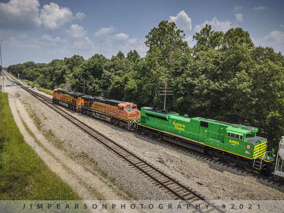 Eastern Maine Railway Shortline 6403 trails at Chiles Junction, West Paducah, Ky

Newly refurbished Eastern Maine Railway (EMRY) 6403, Owned by the New Brunswick Southern Railway (NBSR), trails as the third unit on the northbound Paducah to Centralia, IL BNSF local as it pulls north at Chiles Junction in West Paducah, Kentucky with BNSF 7901 and 6147 leading the way on July 23, 2021. 

Locomotive 6403 is the second of six units that are being refurbished by Progress Rail at Mayfield, KY, for NBSR out of Saint John, NB, Canada. The other units are 6402-6406 and they are all SD70M-2 units and were former NS locomotives. 

According to Wikipedia: The Eastern Maine Railway Company Limited (reporting mark EMRY) is a 99.5 mi U.S. short line railroad owned by the New Brunswick Railway Company, a holding company that is part of "Irving Transportation Services", a division within the industrial conglomerate J.D. Irving Limited.

EMRY was established as a corporate entity on November 10, 1994, by J.D. Irving Ltd. to purchase the 99.5 mile right of way and physical railway assets of the Canadian Pacific Railway's Mattawamkeag Subdivision rail line within the state of Maine, running from its eastern terminus at the CanadaUnited States border, this being the midpoint of the Saint Croix-Vanceboro Railway Bridge at Vanceboro, west to Brownville Junction.

Both EMRY and NBSR began operations on January 6, 1995, approximately 1 week after Canadian Pacific Railway abandoned operations of its Canadian Atlantic Railway (CAR) subsidiary on December 31, 1994. In addition to owning the former CPR tracks in Maine, EMRY was an operating entity for the first several months of existence and had running rights over its sister company NBSR's tracks from the International Boundary east to the yard at McAdam, New Brunswick. In spring 1995 Irving Transportation Services consolidated its railway operations as Eastern Maine Railway Company Limited came under NBSR operational control.

Tech Info: DJI Mavic Air 2 Drone, RAW, 4.5mm (24mm equivalent lens) f/2.8, 1/800, ISO 100.