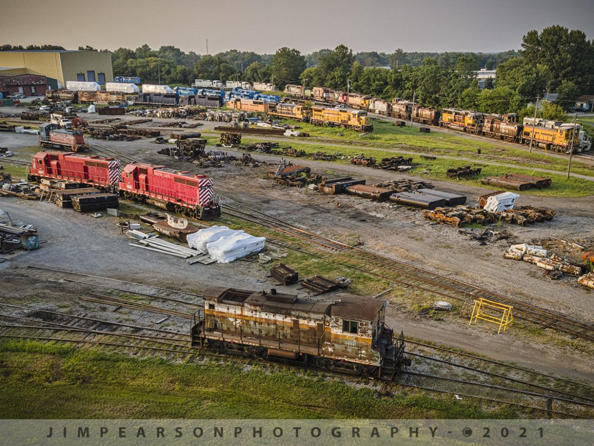 The Progress Rail backyard at Mount Vernon, IL

On July 23, 201 we find old KORAL Switcher 2111 in the backyard of National Railway Equipment shops in Mount Vernon, Illinois along with a variety of newly rebuilt and old locomotives that are used for spare parts and the like. Switcher 2111 is used to move equipment around. Although its seen better days, it still does its job!

According to Wikipedia: "The Korea Railroad Corporation, branded as KORAIL, is the national railway operator in South Korea. Currently, KORAIL is a public corporation, managed by Ministry of Land, Infrastructure and Transportation.

KORAIL operates intercity/regional, commuter/metro and freight trains throughout South Korea, and has its headquarters in Daejeon.

Historically, the South Korean railway network was managed by the Railroad Administration Bureau of the Ministry of Transportation before 1963. On 1 September 1963, the bureau became an agency that was known as Korean National Railroad (KNR) in English. In the early 2000s, split and public corporatization of KNR was decided by the South Korean government, and in 2003, KNR adopted the current KORAIL logo in blue to prepare corporatization.

On 1 January 2005, KNR was split into Korea Railroad Corporation (KORAIL), which succeeded railway operation with the KORAIL logo and name, and Korea Rail Network Authority (KR), which succeeded maintaining tracks."

Tech Info: DJI Mavic Air 2 Drone, RAW, 4.5mm (24mm equivalent lens) f/2.8, 1/200, ISO 100.