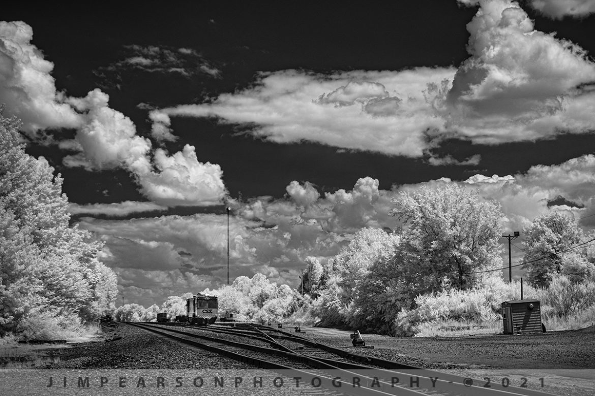 CSX GMS2 track geometry car at PAL west yard, Madisonville, KY. 

On August 4th, 2021, I was headed home with my niece Elaina this afternoon as we passed over the crossing at the Paducah and Louisville Railway yard at Madisonville, Kentucky when I spotted this scene with GMS2 track geometry car sitting pretty much by itself and did an immediate U-turn! The light, sky, clouds, and car were just screaming to me to be photographed in Infrared! After trying different angles and lenses this in the shot I ended up liking the best!

From Wikipedia: "A track geometry car (also known as a track recording car) is an automated track inspection vehicle on a rail transport system used to test several parameters of the track geometry without obstructing normal railroad operations. Some of the parameters generally measured include position, curvature, alignment of the track, smoothness, and the cross level of the two rails. The cars use a variety of sensors, measuring systems, and data management systems to create a profile of the track being inspected."

Tech Info: Fuji XT-1, RAW, Converted to 720nm B&W IR, Fuji 18-55 @32.9mm, f/5, 1/500, ISO 200.