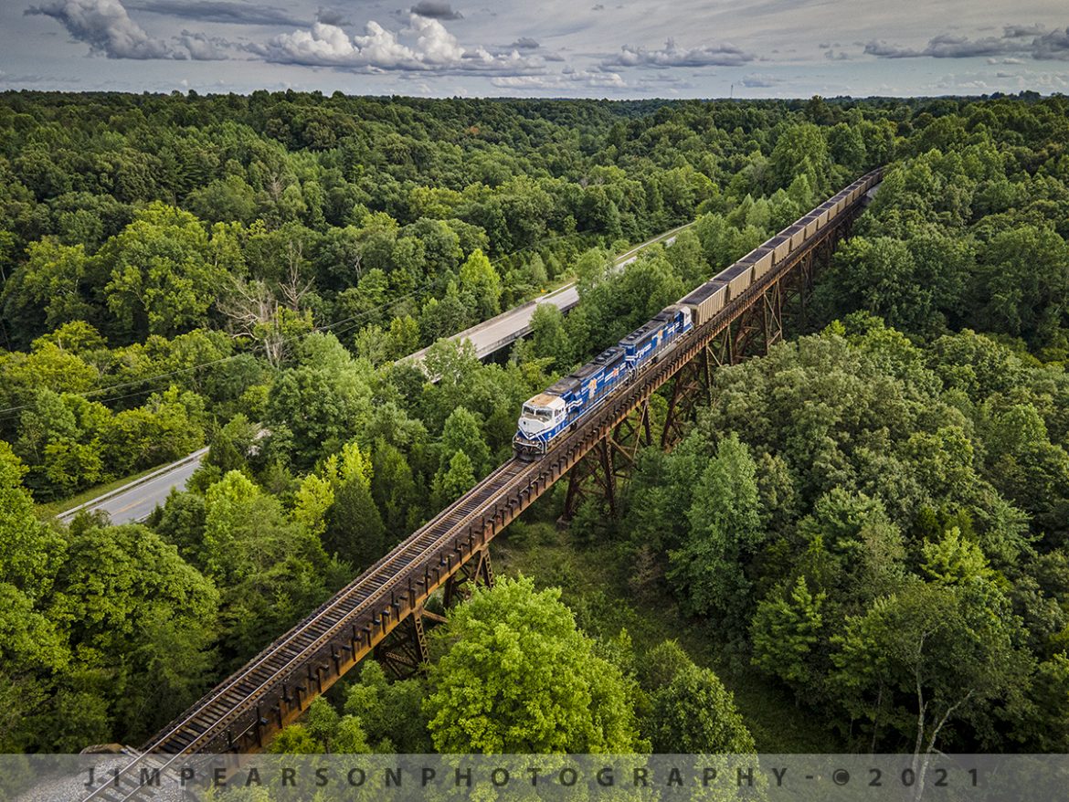 Paducah and Louisville Railway loaded coal at Big Clifty, Kentucky

Paducah and Louisville University of Kentucky locomotives 4522 and 2012 lead the Louisville Gas & Electric loaded coal train across the trestle at Big Clifty, Kentucky as it heads north along highway 62 on its way to the Louisville Gas and Electric power plant in the Kosmosdale neighborhood of Louisville, Kentucky.

According to their website: "The Mill Creek Generation Station is LG&E's largest coal-fired power plant, with a generating capacity of 1,465 megawatts. Mill Creek sits on 544 acres in southwest Jefferson County, Ky.

The late 1960s and early 1970s saw an unprecedented increase in the construction of new industrial, commercial, and residential facilities in the Louisville area.

As customers  demand for energy increased, LG&E needed additional generating capability to guarantee supply and ensure reliability. Mill Creek began commercial operation in 1972 to meet this growing demand."

Tech Info: Wide Photo: DJI Mavic Air 2 Drone, RAW, 4.5mm (24mm equivalent lens) f/2.8, 1/640, ISO 100, August 17, 2021.