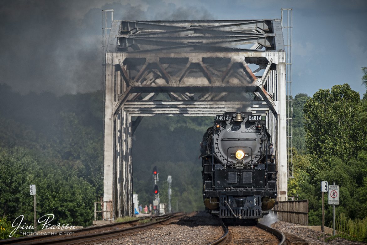 The crowd was huge at Chester, Illinois and just didn't want to let the Big Boy leave which delayed its departing from there. This made me and a lot of other railfans stand around at a grade crossing waiting for this shot for over an hour and a half in the 100-degree weather, but it was worth it for my last shot of Union Pacific 4014 on its 2021 tour! 

I ended up cropping this shot much tighter than I actually shot it thanks to two guys in cowboy hats that walked down next to the tracks in everyone's shot, but that stuff happens and after working with this shot, I like how this in-your-face photograph turned out! Sometimes when you're doing a chase that is a popular as this in the hobby, you just must adjust accordingly as everyone wants their shot, even the cowboys!

Here engineer Ed Dickens and the rest of the Union Pacific Big Boy 4014 crew keeps an eye on the tracks ahead as it crosses the Kaskaskia River on the UP Chester Subdivision at Brewerville, Illinois.

Tech Info: Nikon D800, RAW, Sigma 150-600mm @ 195mm, f/6, 1/1000, ISO 560, August 28, 2021.