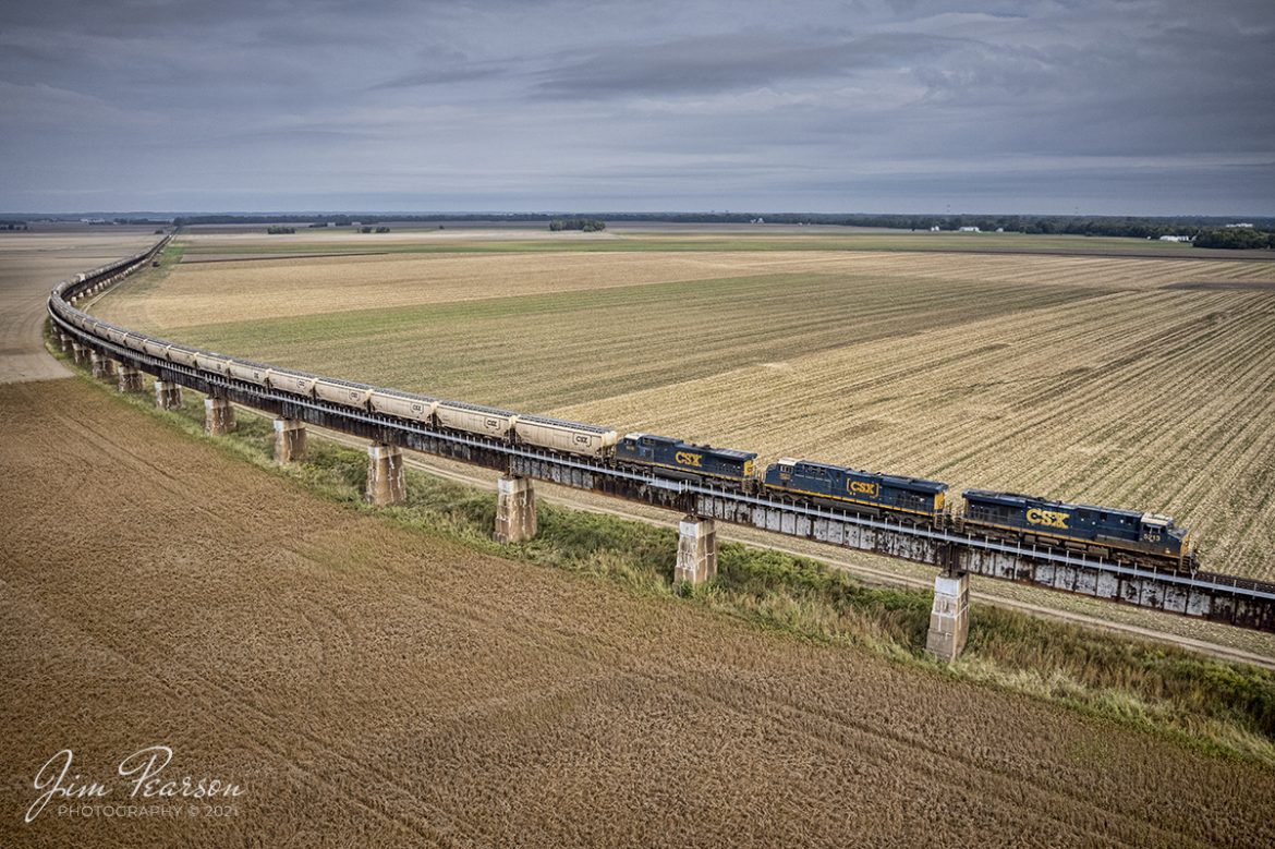 It's that time of the year when the fall harvests begin moving south on the CSX Henderson Subdivision as with many other railroads around the country. Here I caught CSX G390, a Grain Express unit train, headed up by CSXT 5213, 3021 and 9010, as they head south up the viaduct to the Ohio River between Rahm, Indiana and Henderson, Kentucky, on October 13th, 2021. 

During the rainy season these fields fill up with the overflow from the Ohio River, which is the reason this viaduct was built by the Louisville and Nashville Railroad.

Tech Info: DJI Mavic Air 2S Drone, RAW, 22mm, f/2.8, 1/2000, ISO 110.

#trainphotography #railroadphotography #trains #railways #dronephotography #trainphotographer #railroadphotographer #jimpearsonphotography