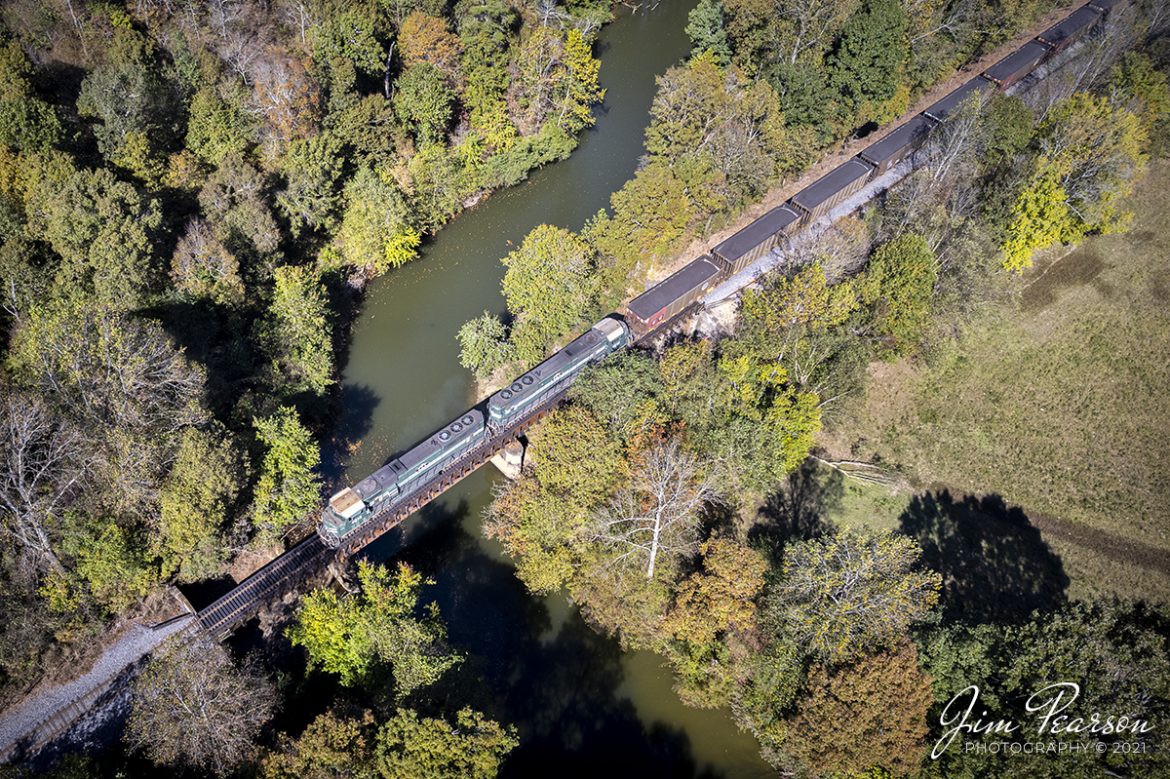 Paducah and Louisville Railway 4518 leads a southbound load of coal over the Tradewater River at Dawson Springs, Kentucky, with a splash of fall color beginning to show in the surrounding trees.

According to Wikipedia: The Paducah & Louisville Railway is a Class II railroad that operates freight service between Paducah and Louisville, Kentucky. The line is located entirely within the Commonwealth of Kentucky. The 270-mile line was purchased from Illinois Central Gulf Railroad in August of 1986.

The 270-mile (430 km) line was purchased from Illinois Central Gulf Railroad in August 1986 and the 223-mile (359 km) main route runs between Paducah and Louisville, with branch lines from Paducah to Kevil and Mayfield, Kentucky, and another from Cecilia to Elizabethtown, Kentucky. The PAL interchanges with Burlington Northern Santa Fe (BNSF) and Canadian National (CN), formerly Illinois Central Railroad, in Paducah

Tech Info: DJI Mavic Air 2S Drone, RAW, 22mm, f/2.8, 1/730, ISO 100.

#trainphotography #railroadphotography #trains #railways #dronephotography #trainphotographer #railroadphotographer #jimpearsonphotography