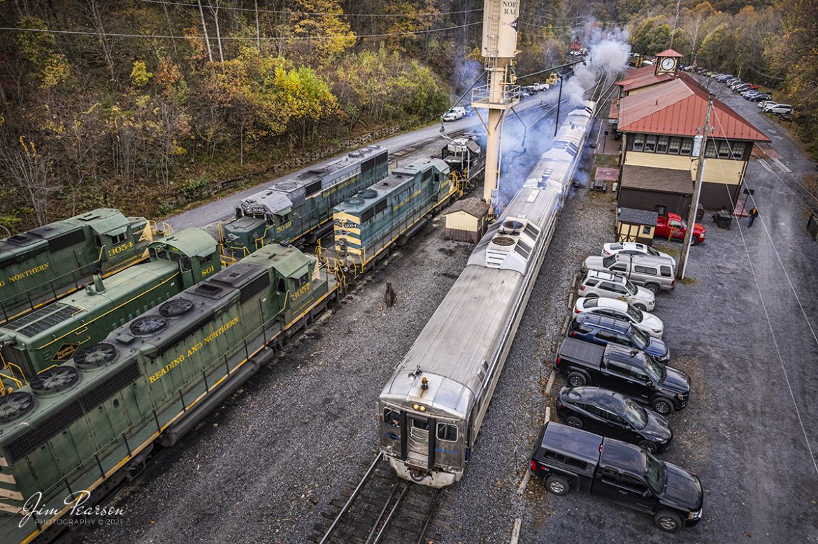 Reading Blue Mountain and Northern Railroad Rail Diesel Car 9168 leads as the engineer pulls past the depot at Port Clinton, Pennsylvania on a beautiful fall afternoon on the mountain railroad on November 4th, 2021.

According to their website: The Reading and Northern Railroad owns and operates self-propelled Rail Diesel Cars #9166, #9167, and #9168. The cars were built by the former Budd Company of Philadelphia in the 1950's for commuter use by various railroads.  The Reading and Northern Railroad invested a lot of money on all three cars with many updates including an ornately painted ceiling in all cars.

The #9166 includes functioning windows and a clean restroom. This RDC consists of a coach and a kitchen in which refreshments and snacks are served.  Make new friends at the counter area or sit-down area of the refreshment area!

The #9167 is also a complete coach with padded seats that flip, functioning windows, and a clean restroom on board.

The #9168 contains comfortable bus-style seating which maneuver in both directions. This coach also includes functioning windows and a clean restroom.

According to Wikipedia: The Reading Blue Mountain and Northern Railroad, sometimes shortened to Reading and Northern Railroad, is a regional railroad in eastern Pennsylvania. Its headquarters is in Port Clinton. The RBMN provides freight service on 300 miles of track.

Tech Info: DJI Mavic Air 2S Drone, RAW, 22mm, f/2.8, 1/320, ISO 100.