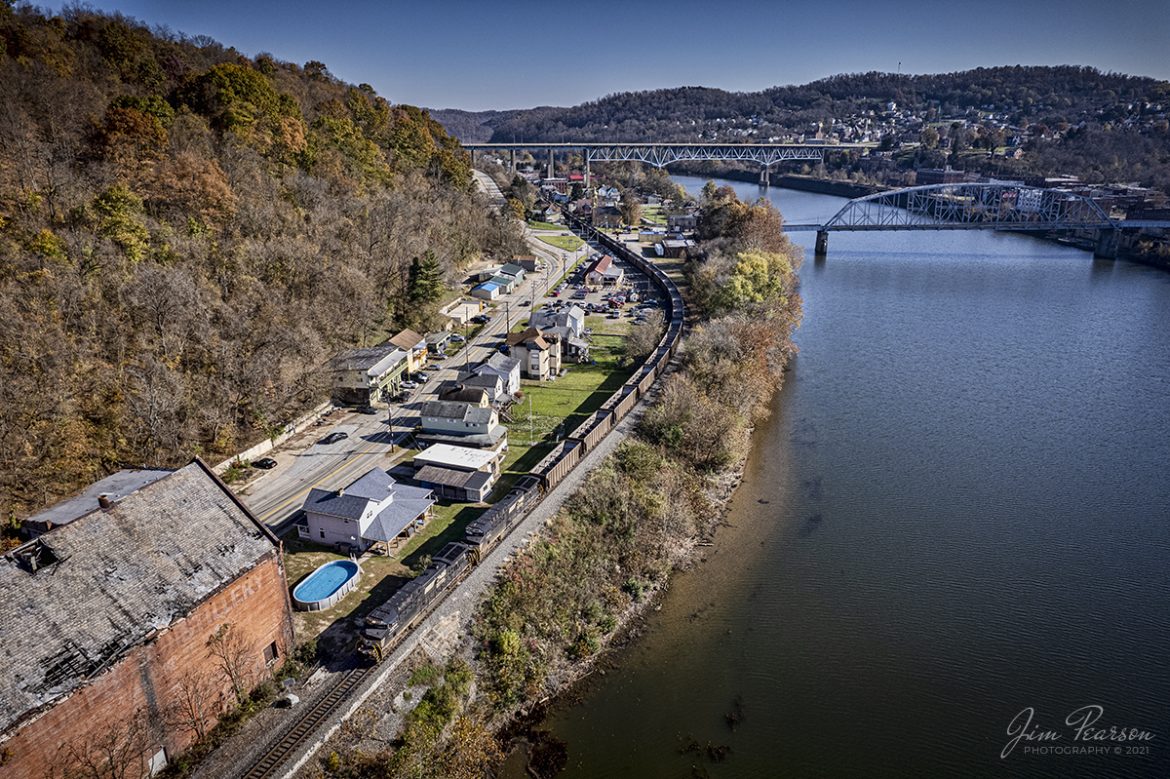 Norfolk Southern 4290 leads an empty coal train north out of Brownsville, Pennsylvania along the Monongahela River on the NS Mon line on a beautiful fall morning.

According to Wikipedia: The Mon Line is an 85-mile-long Norfolk Southern rail line which runs along the Monongahela River for most of its route. 

The predecessor of this line is the Pittsburgh, Virginia, and Charleston Railroad. The northern portion (Pittsburgh to West Brownsville) of the line is the former main line of the Monongahela Division of the Pennsylvania Railroad, and the southern portion (West Brownsville to Waynesburg) was once part of the Monongahela Railway's Waynesburg Southern Branch.

Its northern terminus was formerly at the junction with the Panhandle Route at the Panhandle Bridge in Pittsburgh, and its southern terminus was near Brownsville, Pennsylvania where it had a connection to the Monongahela Railway.

Conrail transferred the West Brownsville to Waynesburg trackage from the Waynesburg Southern Branch to the former main line of the PRR Monongahela Division and it became the new Mon Line.

Tech Info: DJI Mavic Air 2S Drone, RAW, 22mm, f/2.8, 1/1250, ISO 200.

#trainphotography #railroadphotography #trains #railways #dronephotography #trainphotographer #railroadphotographer #jimpearsonphotography