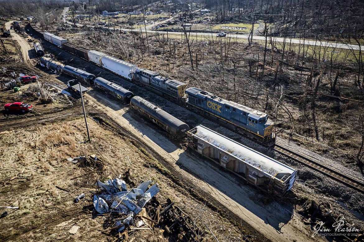 Life moves on and so do the trains as in this shot of the Casky to Madisonville, Ky local J732 on its way north through the rubble and derailed Q500 from the tornado that passed through the region on December 10th. Here we find CSXT 5421 and 100 leading the daily local north on the Henderson Subdivision through Barnsley, Ky on December 20th, 2021.


Barnsley was one of many communities that suffered catastrophic damage to the community during the recent tornado. Fortunately, there were no fatalities in this community and even a rescue of two toddlers that took a ride on the tornado. They were in a bathtub and wrapped in blankets by their grandmother, who also walked away from her destroyed home. They were found by two Hopkins County Deputy Sheriffs and other rescue workers safe and sound with no physical injuries.


If youd like to watch the actual rescue it is in last Sunday's 60 Minutes broadcast about the storm. Its available online. 


Tech Info: DJI Mavic Air 2S Drone, RAW, 22mm, f/2.8, 1/1000, ISO 200.


#trainphotography #railroadphotography #trains #railways #jimpearsonphotography #trainphotographer #railroadphotographer