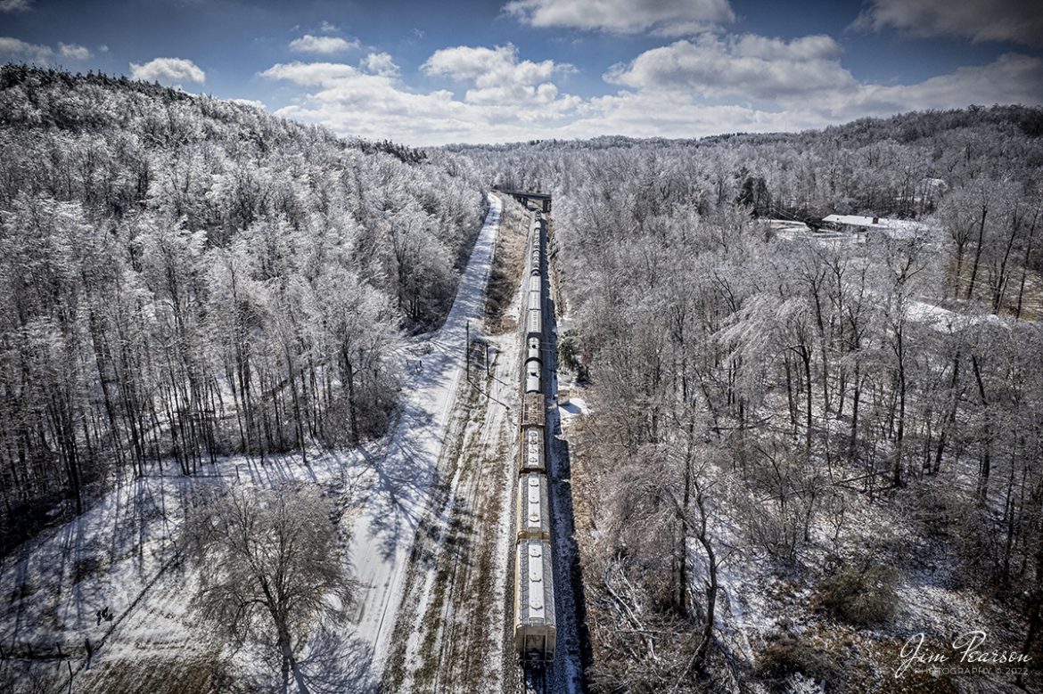 A short local, CSX J732 (Hopkinsville to Madisonville, Ky and return) prepares to pass under the highway 41 overpass at Morons Gap, Kentucky as it heads south with its short train on the Henderson Subdivision on February 5th, 2022.

According to The Kentucky Atlas and Gazetteer Website: Mortons Gap is a Hopkins County city on US 41 about five miles south of Madisonville, Kentucky. Named for Thomas Morton who settled in a gap in an east-west ridge in the southern part of the county. He built a house there circa 1805. The gap has long been used to travel through the area and the railroad and US 41 both run through it. The town was established by the South Diamond Mining Company circa 1871. Mortons Gap was incorporated in 1888. The Mortons Gap post office opened in 1871. The population in 2010 was 863. It was serviced by the Louisville and Nashville Railroad in the early years and now the line is owned by CSXT.

Tech Info: DJI Mavic Air 2 Drone, RAW, 4.5mm (24mm equivalent lens) f/2.8, 1/5000, ISO 200.

#trainphotography #railroadphotography #trains #railways #jimpearsonphotography #trainphotographer #railroadphotographer