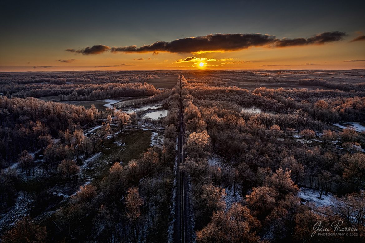 The sun sets over the Paducah and Louisville Railway as the sun rakes across the ice-covered trees at Richland, Ky on February 5th, 2022, in this ultrawide angle shot from my DJI Air 2S drone. 

The recent weather front that passed through the region left a spectacular display of ice in the trees for several days. Thankfully it didnt cause much disruption in my area, unlike the last ice storm through here that left me without power for 6 days in 2009!

Tech Info: DJI Mavic Air 2 Drone, RAW, 4.5mm (24mm equivalent lens) f/2.8, 1/1000, ISO 110, underexposed by 3 stops for the sun.

#trainphotography #railroadphotography #trains #railways #jimpearsonphotography #trainphotographer #railroadphotographer