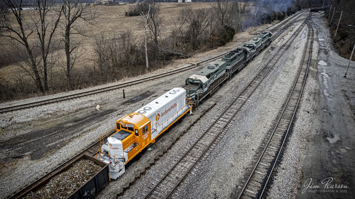 Paducah and Louisville Railway local Z464, with PAL 2109, 2110, 2111 and 2118, back into CSX Atkinson Yard at Madisonville, Kentucky with what appears to be a newly rebuilt locomotive, CAGX 1039 (can't find any information on this leasing company) with Ardent Mills Markings trailing in the line of power on February 25th, 2022.

From what Ive been told by folks much smarter than me when it comes to locomotive power, it appears to be either a GP7 or GP9. 

If anyone has more information I'd appreciate you adding it to the comments!

According to Wikipedia: Ardent Mills was born out of a long history of community mills coming together. We are an independent joint venture by combining ConAgra Mills and Horizon Milling® and we have over 150 years of rich milling history. Our history is tied to the legacies of the individual mills and facilities that form us, and were proud to look towards the future with an appreciation of the past.

Tech Info: DJI Mavic Air 2S Drone, RAW, 22mm, f/2.8, 1/500, ISO 110.

#trainphotography #railroadphotography #trains #railways #dronephotography #trainphotographer #railroadphotographer #jimpearsonphotography